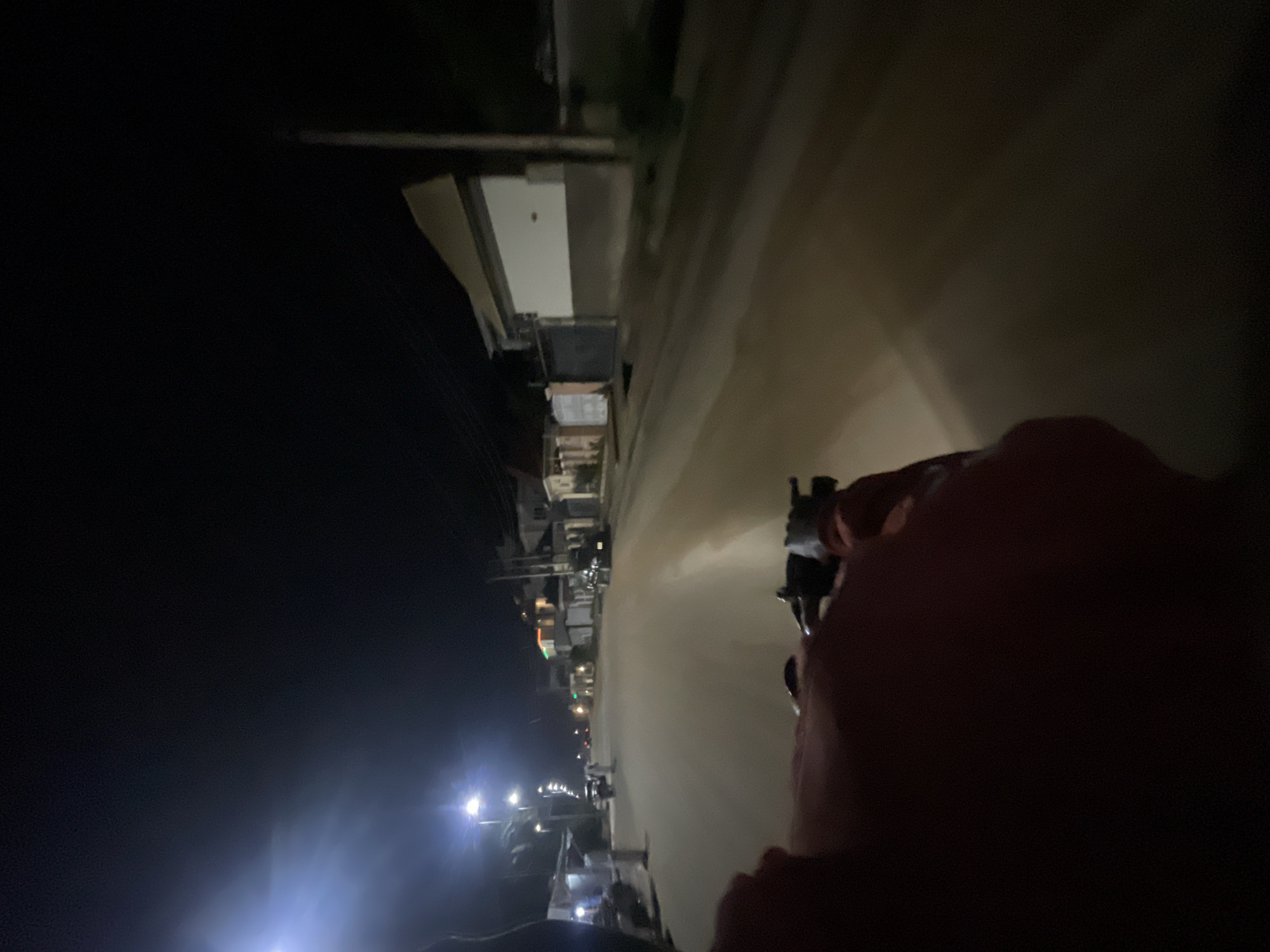 Motorcycle rider travels through nighttime Abuja streets
