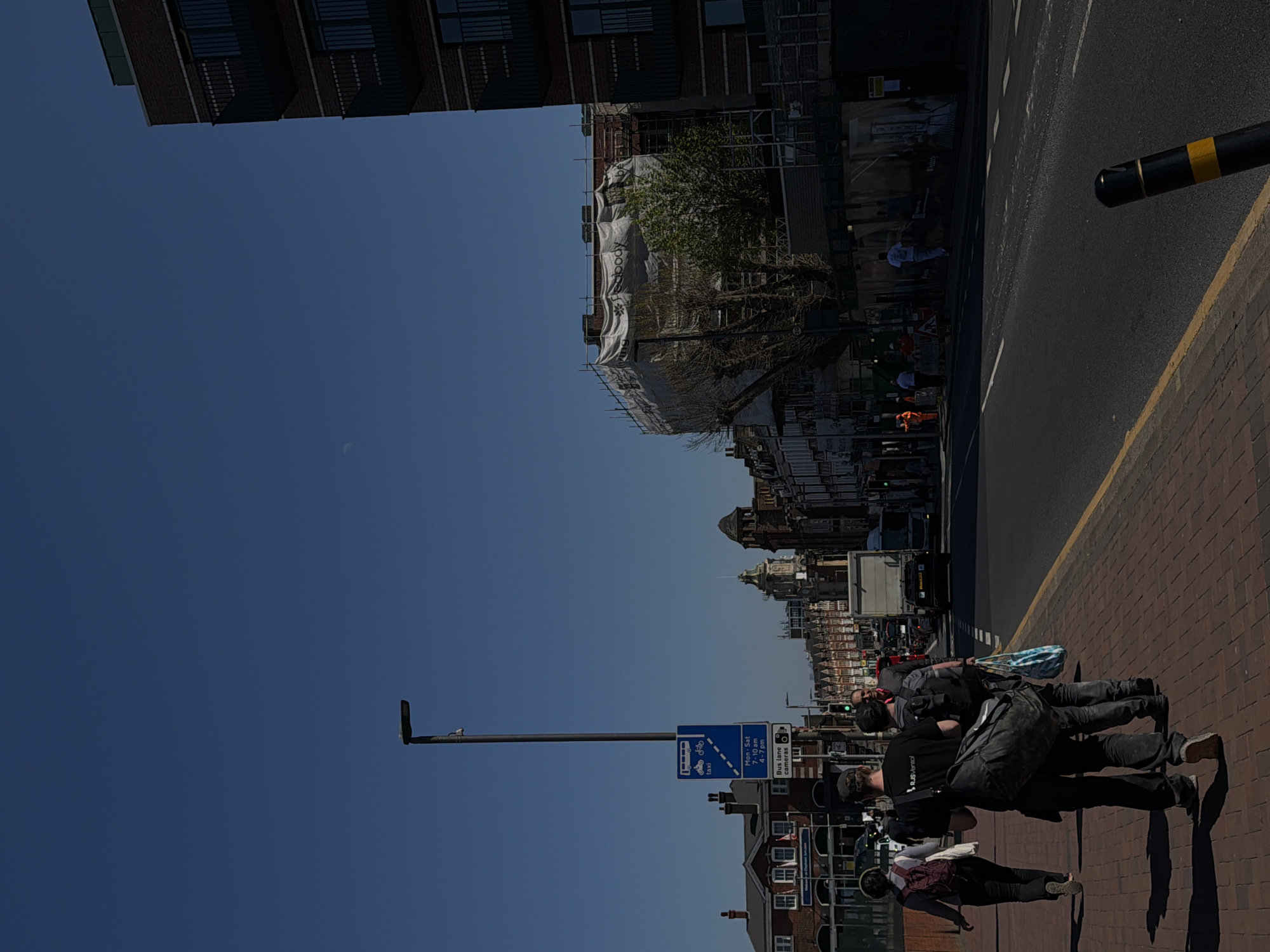 London street scene photographed sideways under clear blue sky