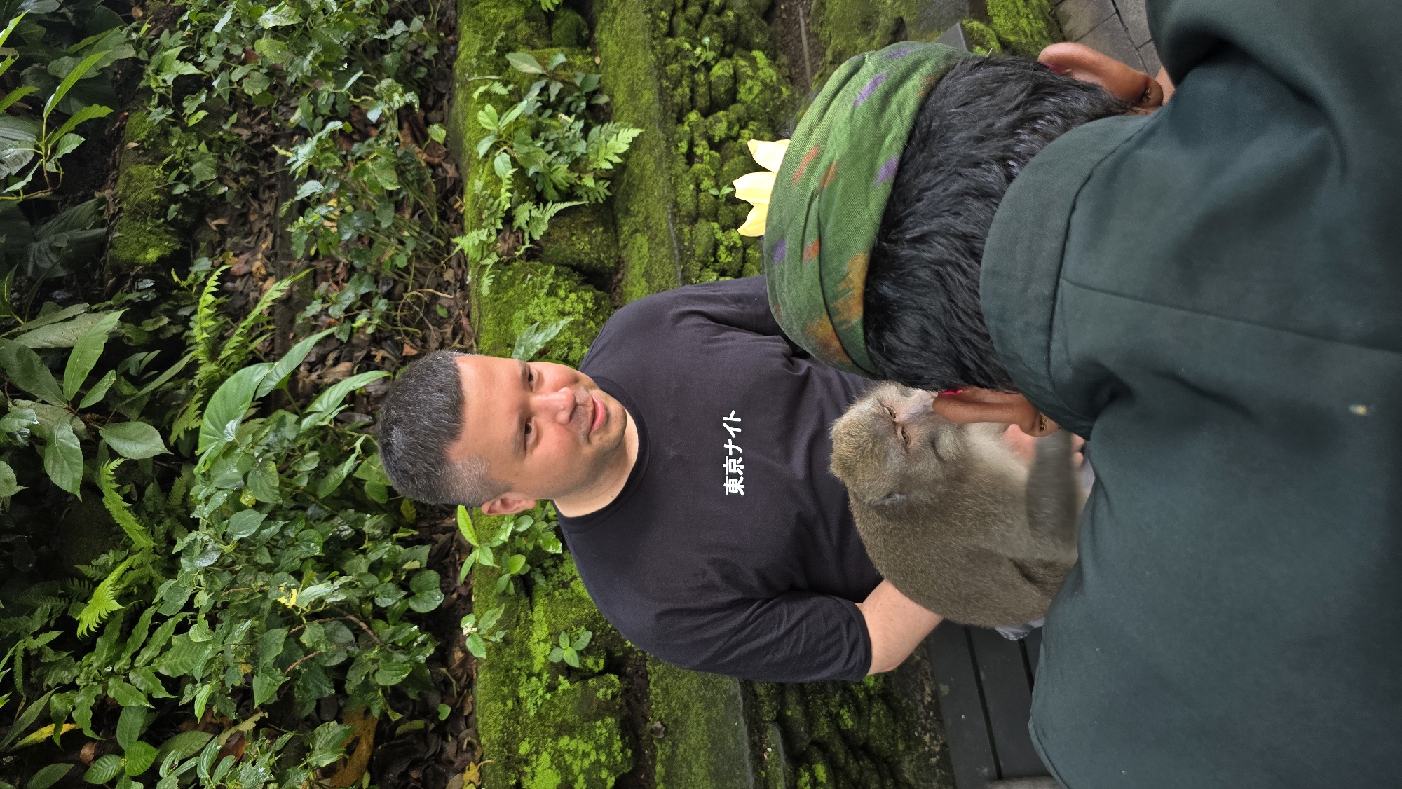 Tourists pose with monkeys at Ubud sanctuary
