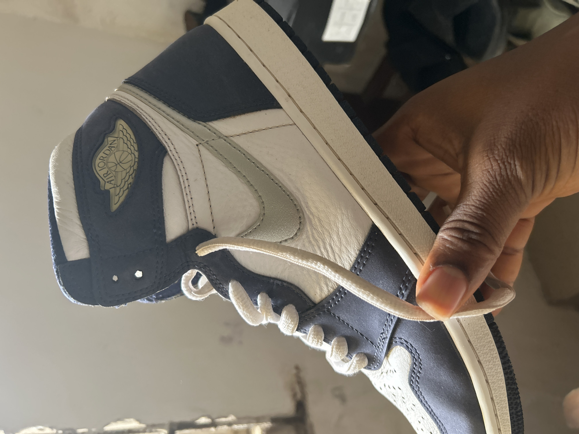 Person examines Nike Air Jordan sneakers in Ashipa, Nigeria
