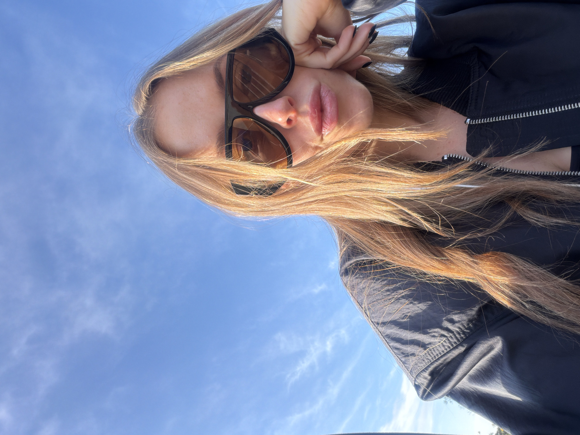 Woman captures selfie with Hollywood Hills landscape views