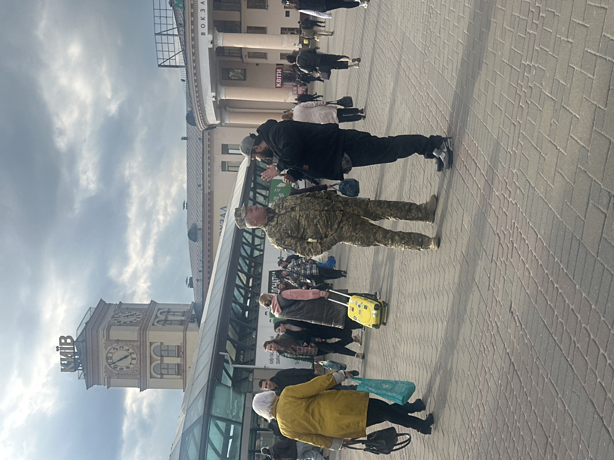 Pedestrians with luggage gather in Kyiv public square