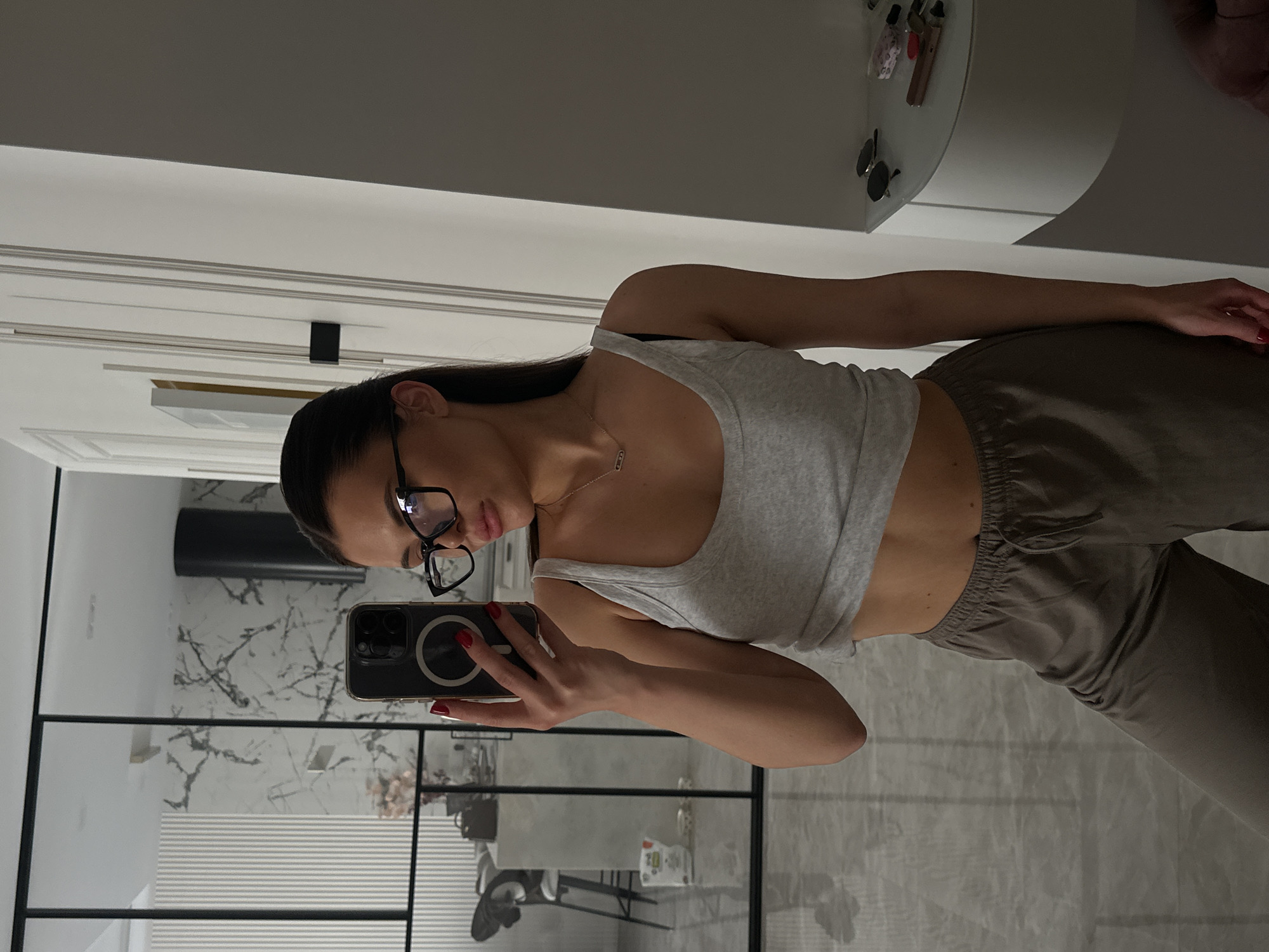 Mirror selfie in a modern Kyiv apartment, casual morning.
