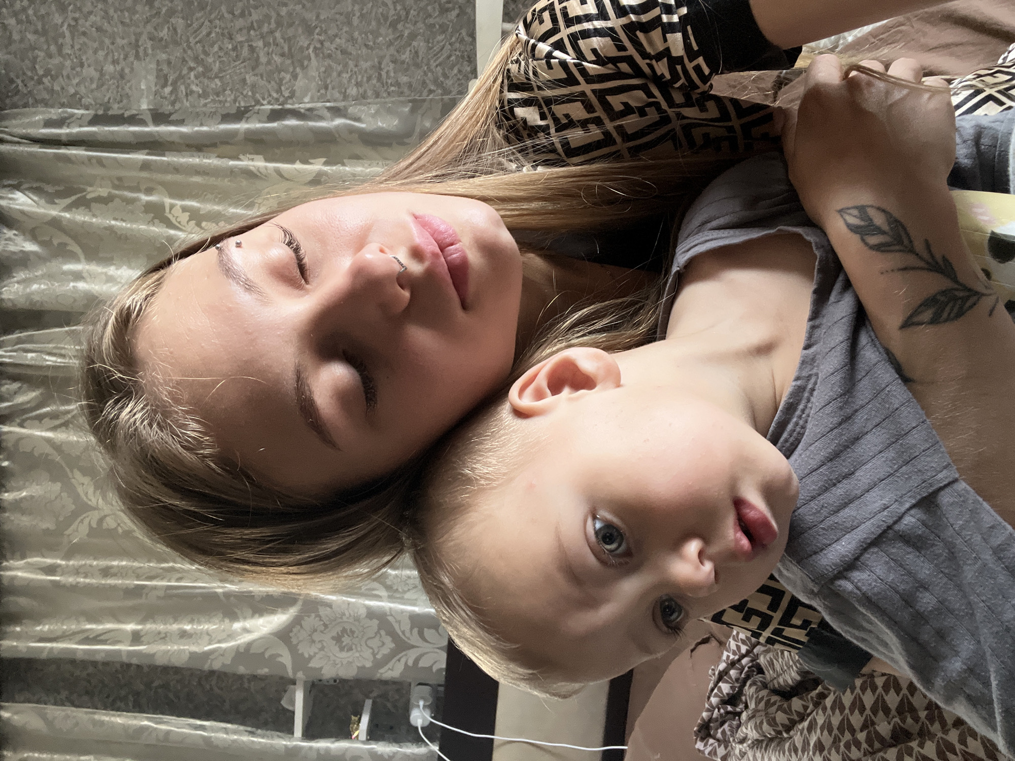 Mother and child rest together in early morning domestic moment