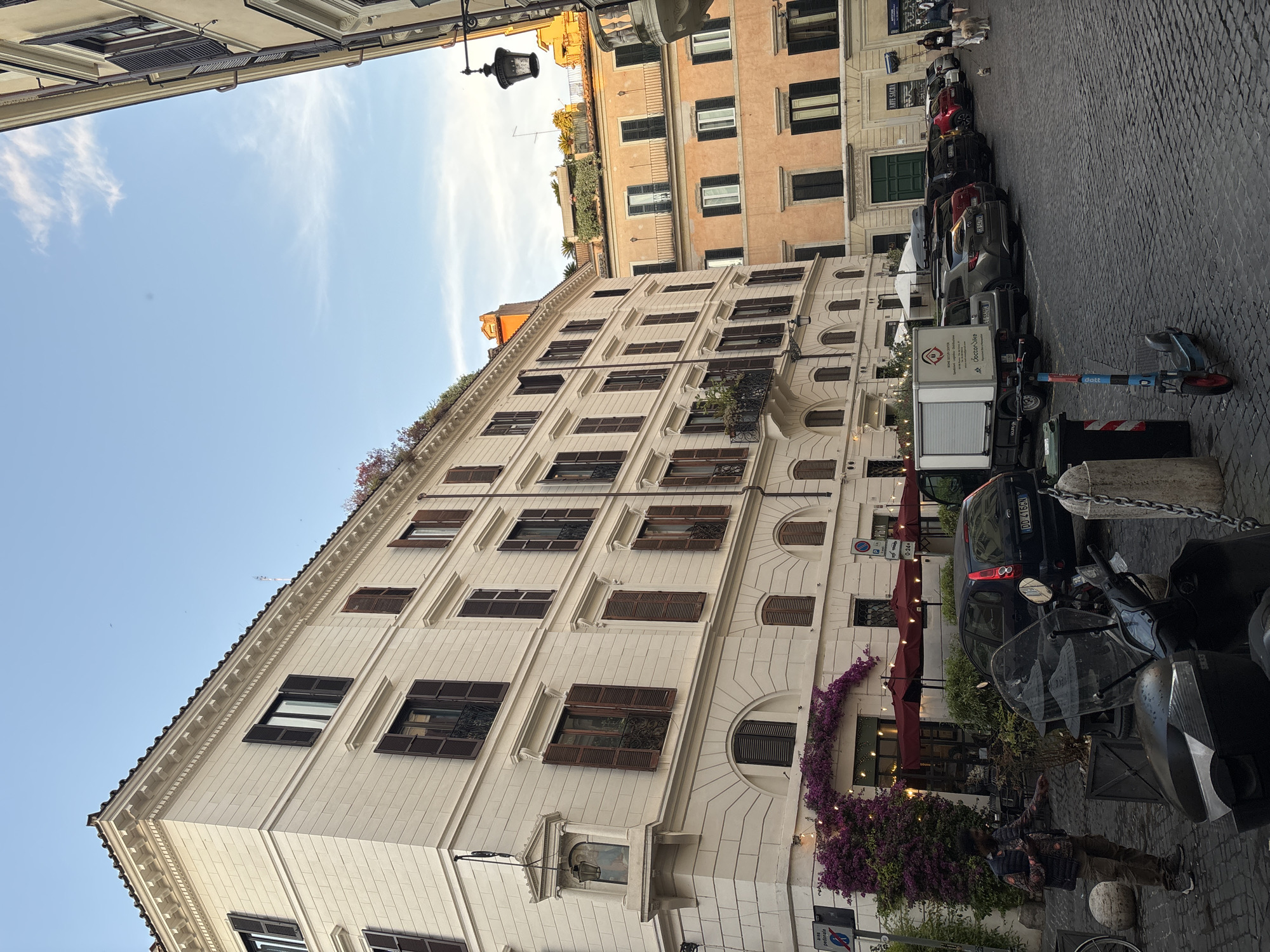 Rome street scene shows historic buildings including religious structure
