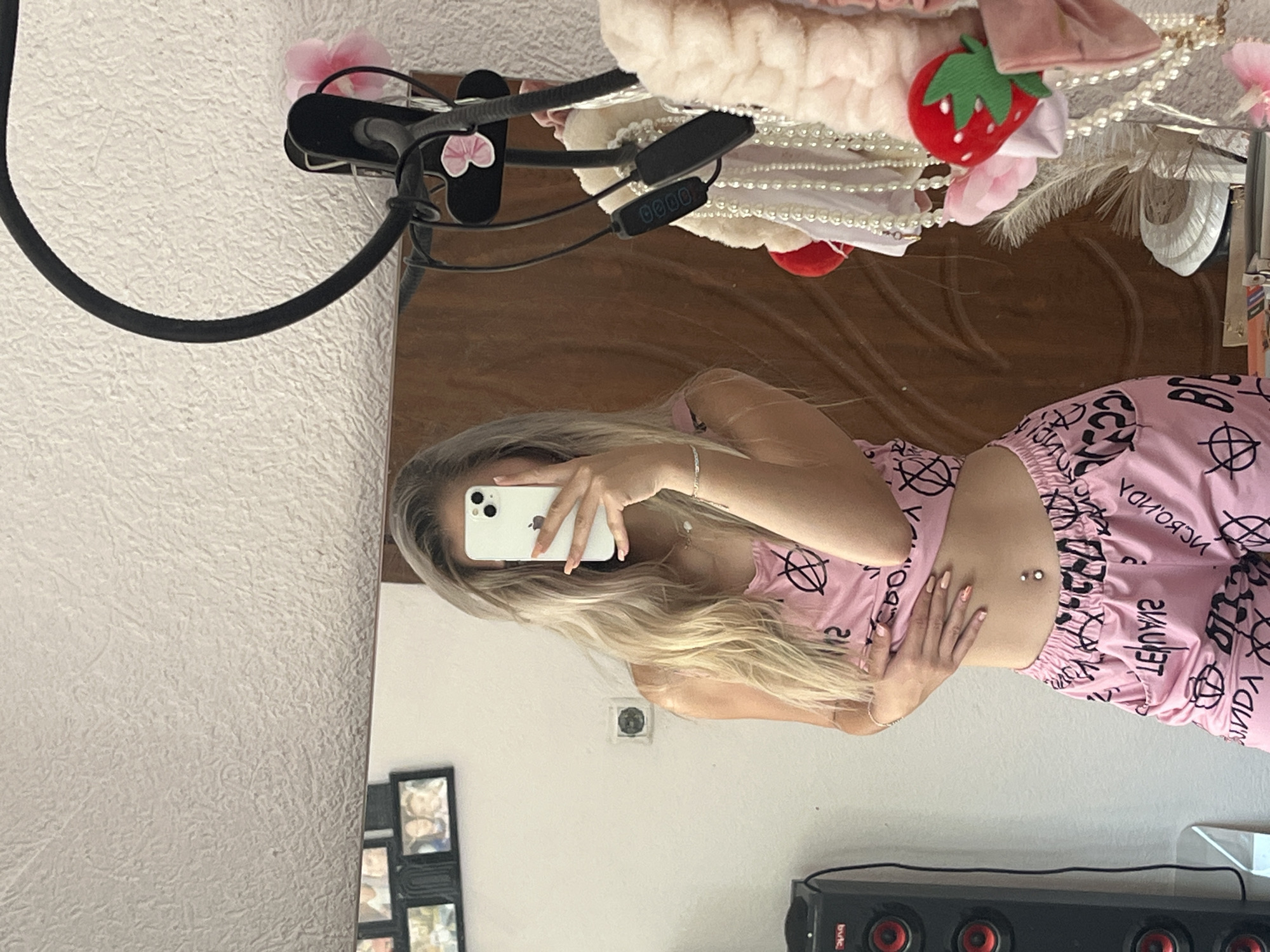 Mirror selfie in pink graphic pajamas, relaxed home setting.