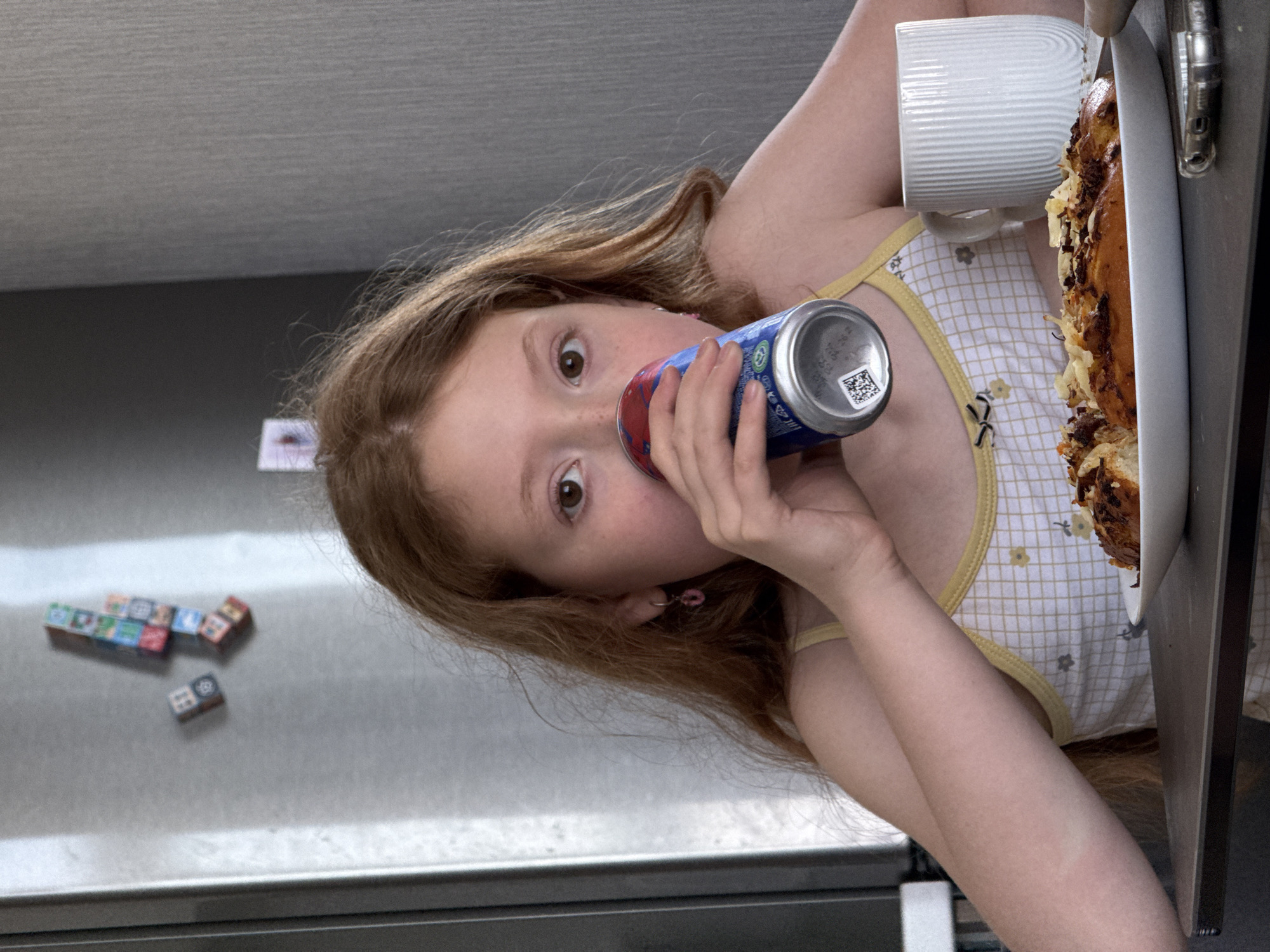Girl drinks from colorful can in Rostov-on-Don