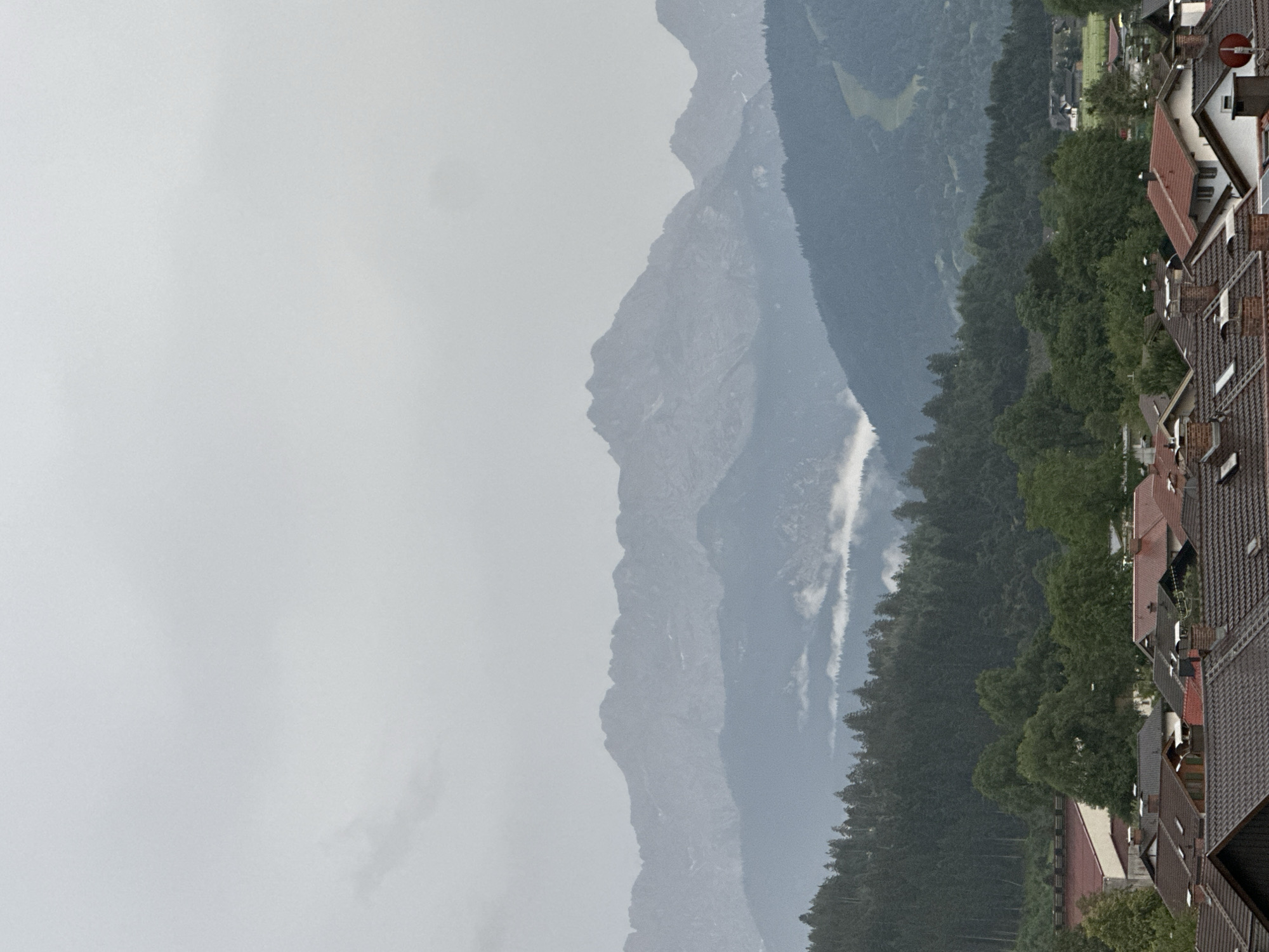 Overcast evening over Garmisch-Partenkirchen's rooftops and misty Alps
