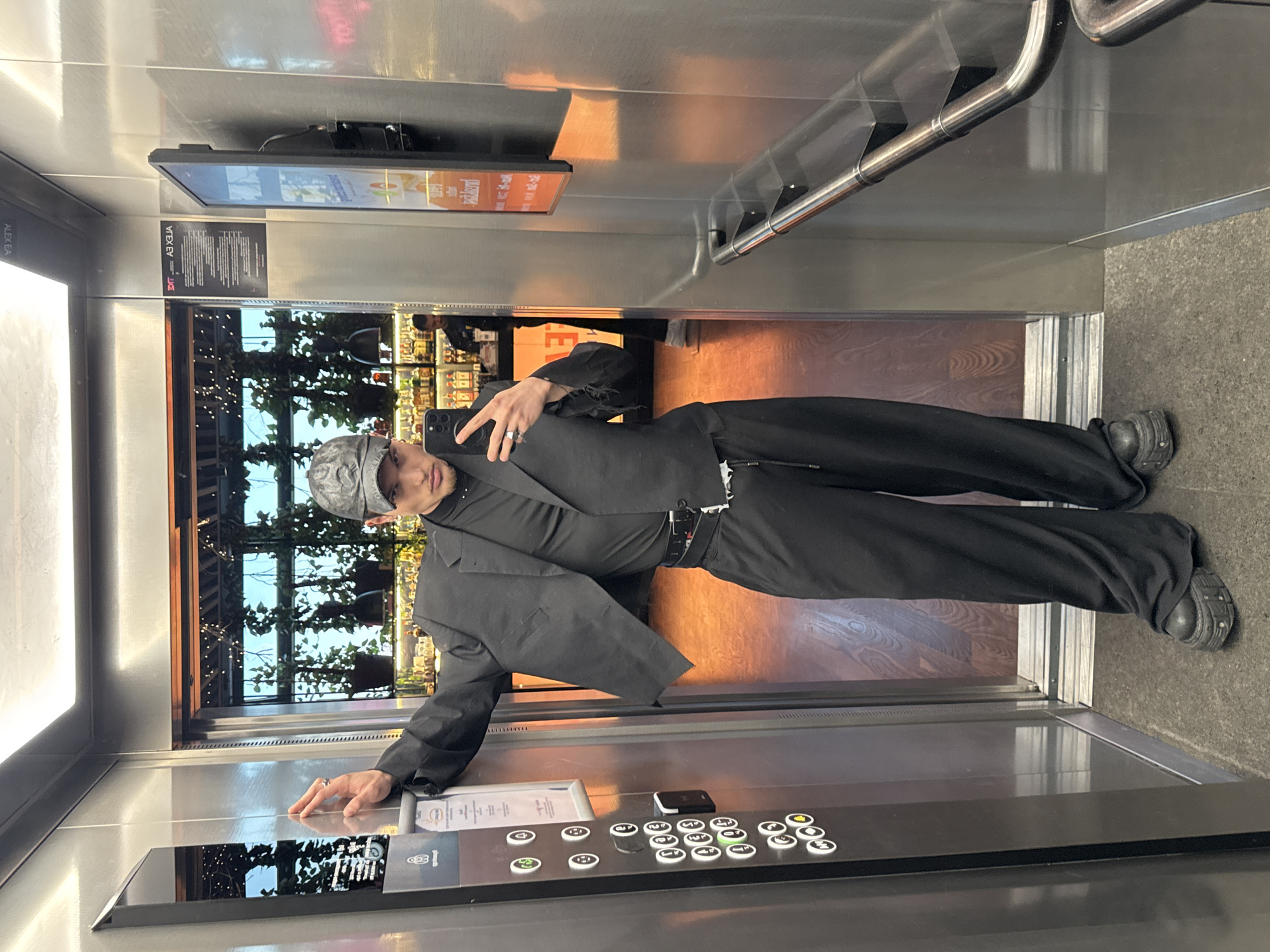 Person takes elevator selfie, stands on doormat in Sofia