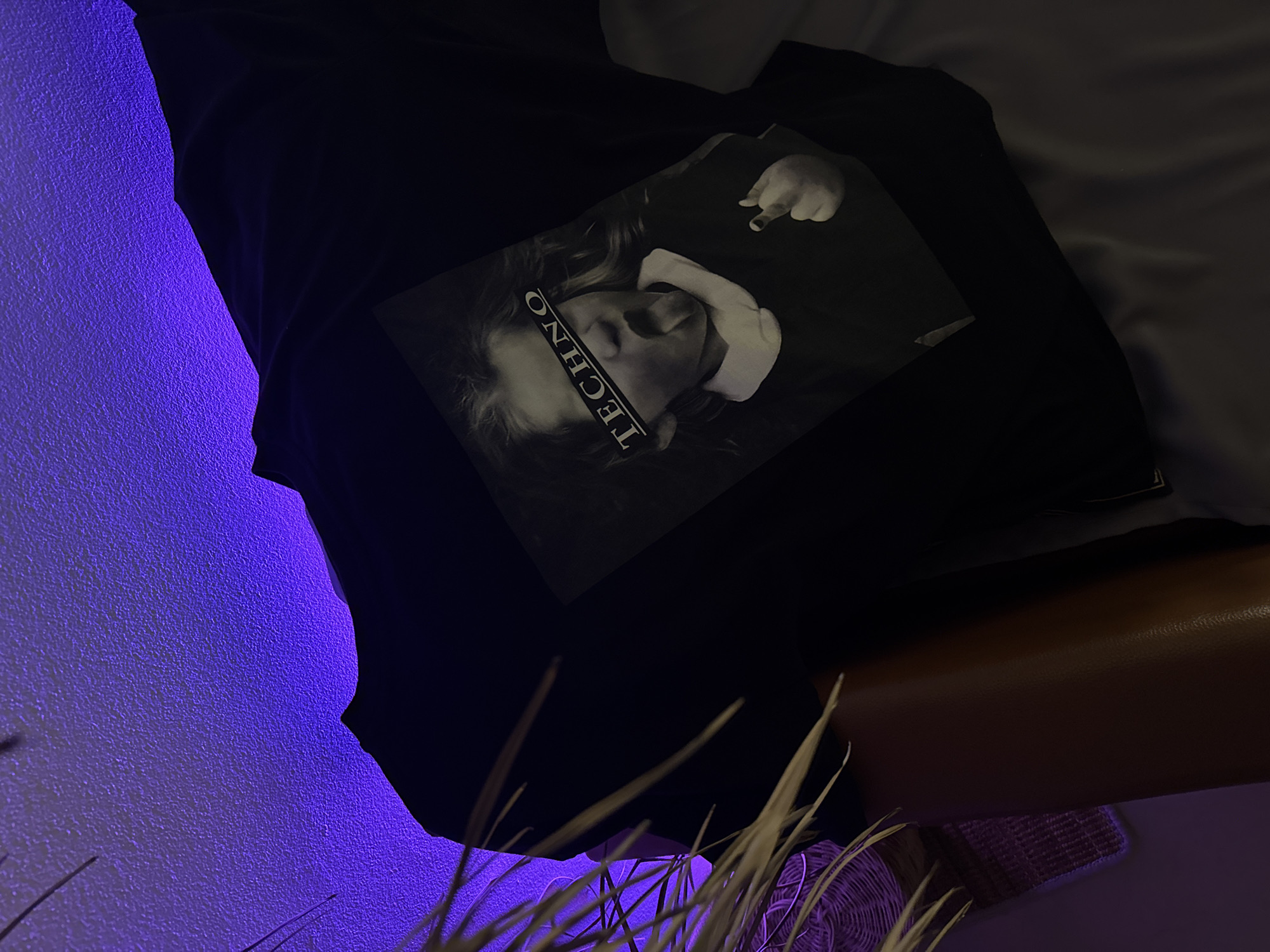 Purple-lit room interior with personal items in Baan Mae Nam