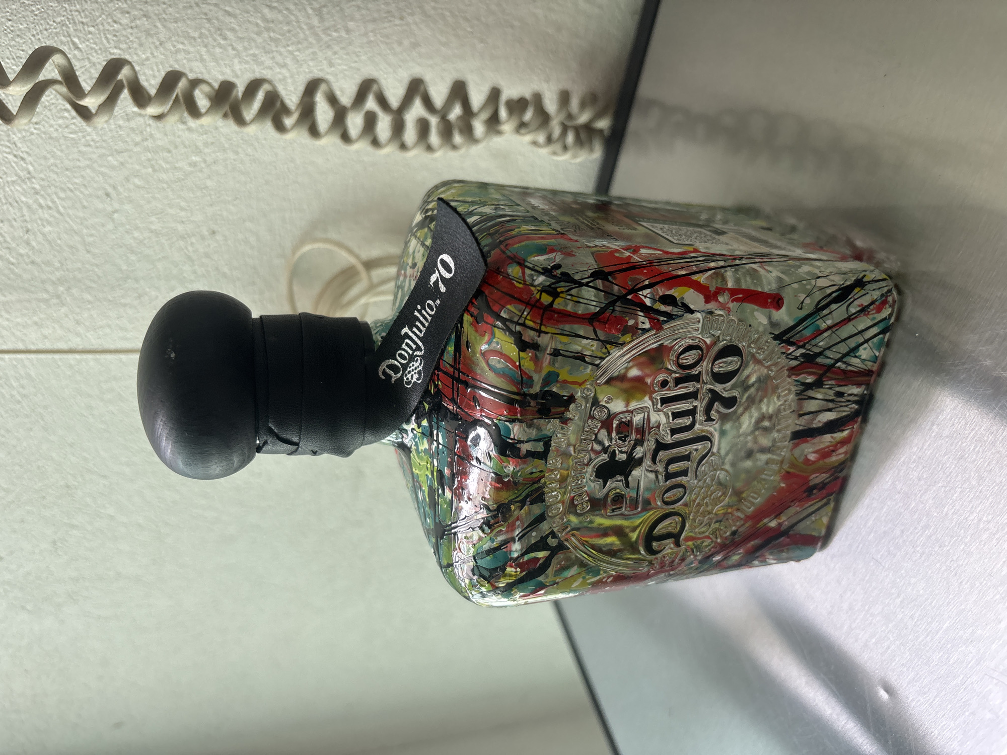 Paint-splattered tequila bottle documented in Mexico City suburb