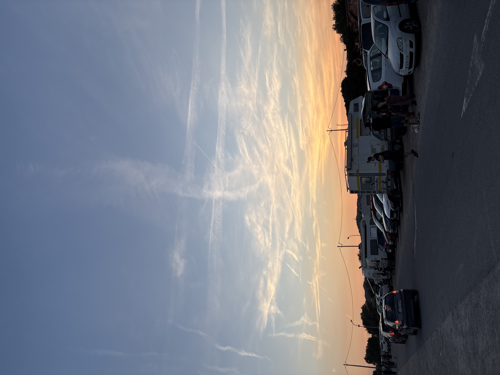 Evening gathering around vehicle in Cunit parking lot