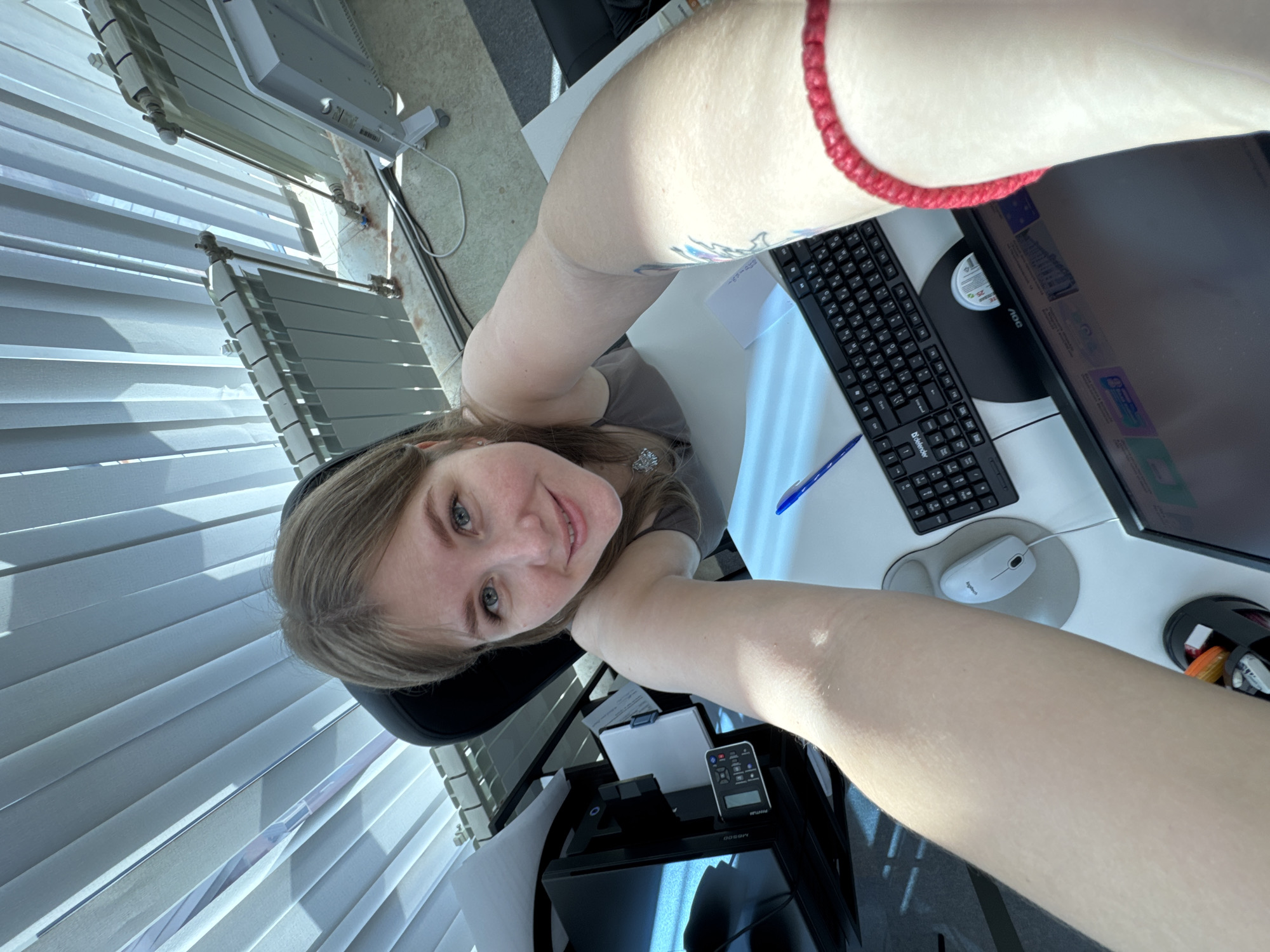 Person takes early morning selfie at computer desk in Perm