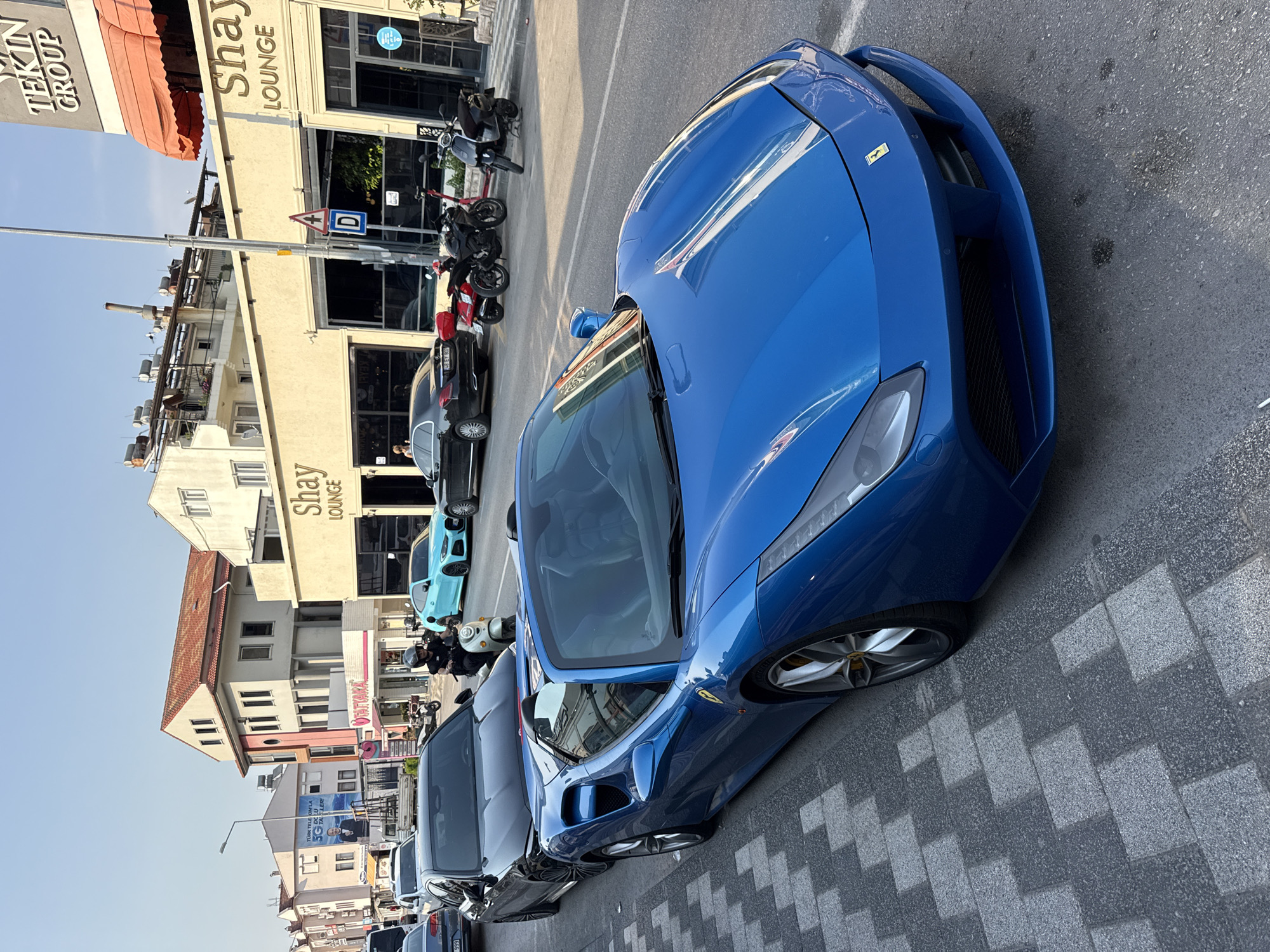 Blue Ferrari convertible parked on a Fethiye street