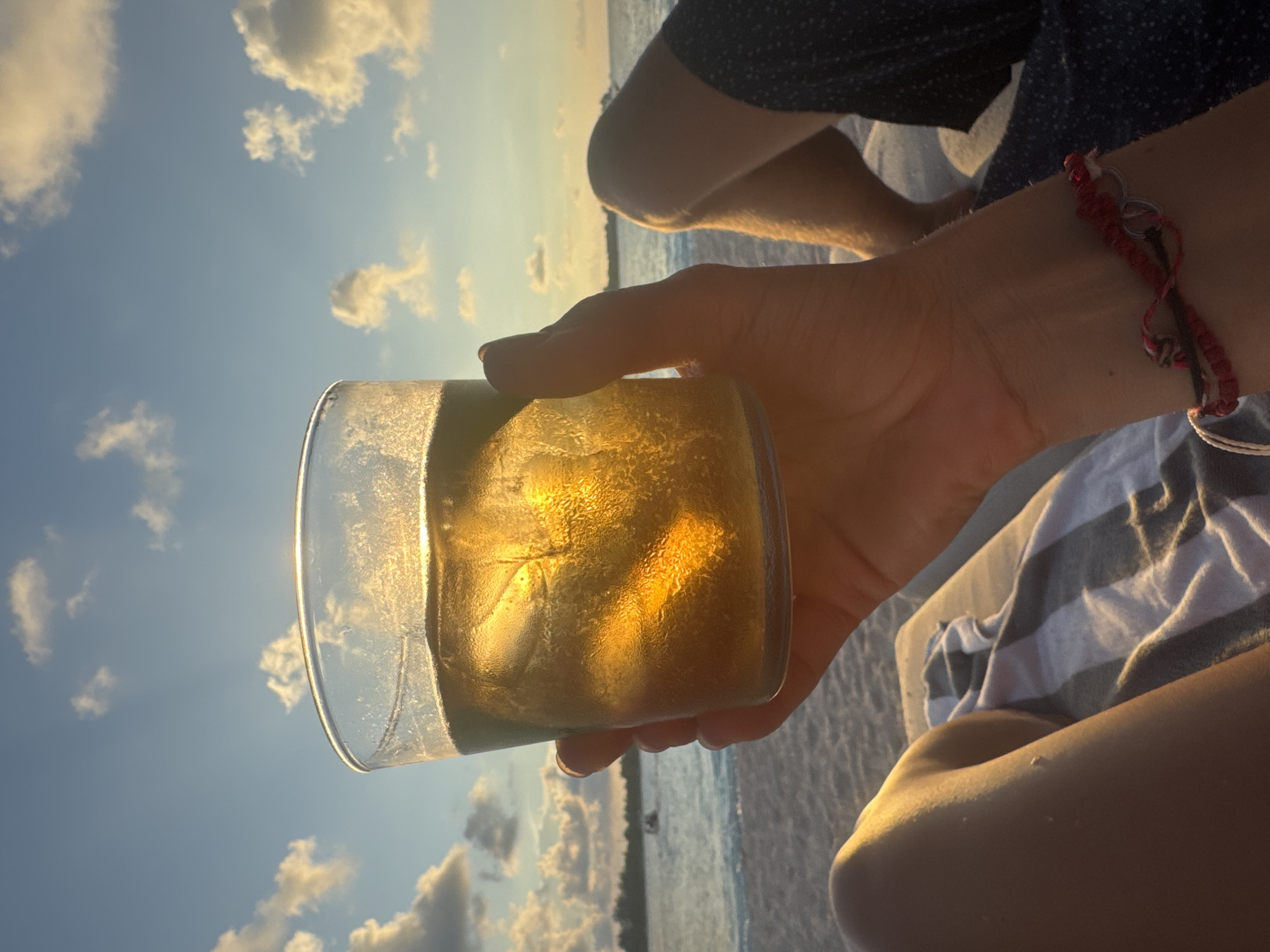 Sunset drinks and serene skies captured at Indonesian beach