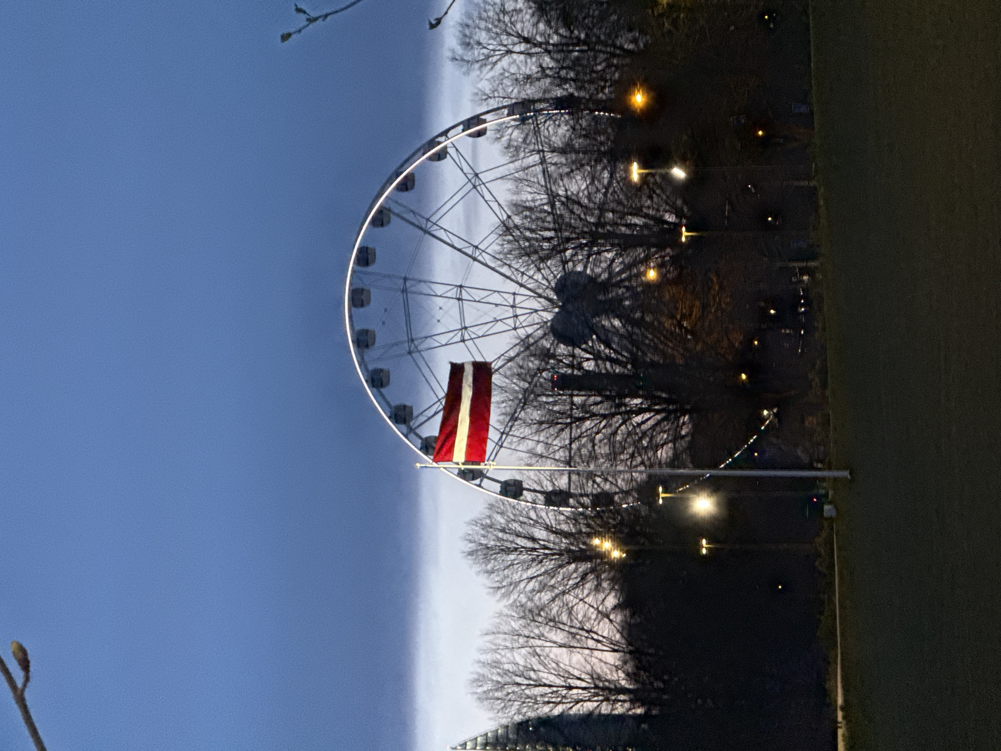 Evening twilight scenes captured in Riga featuring Ferris wheel