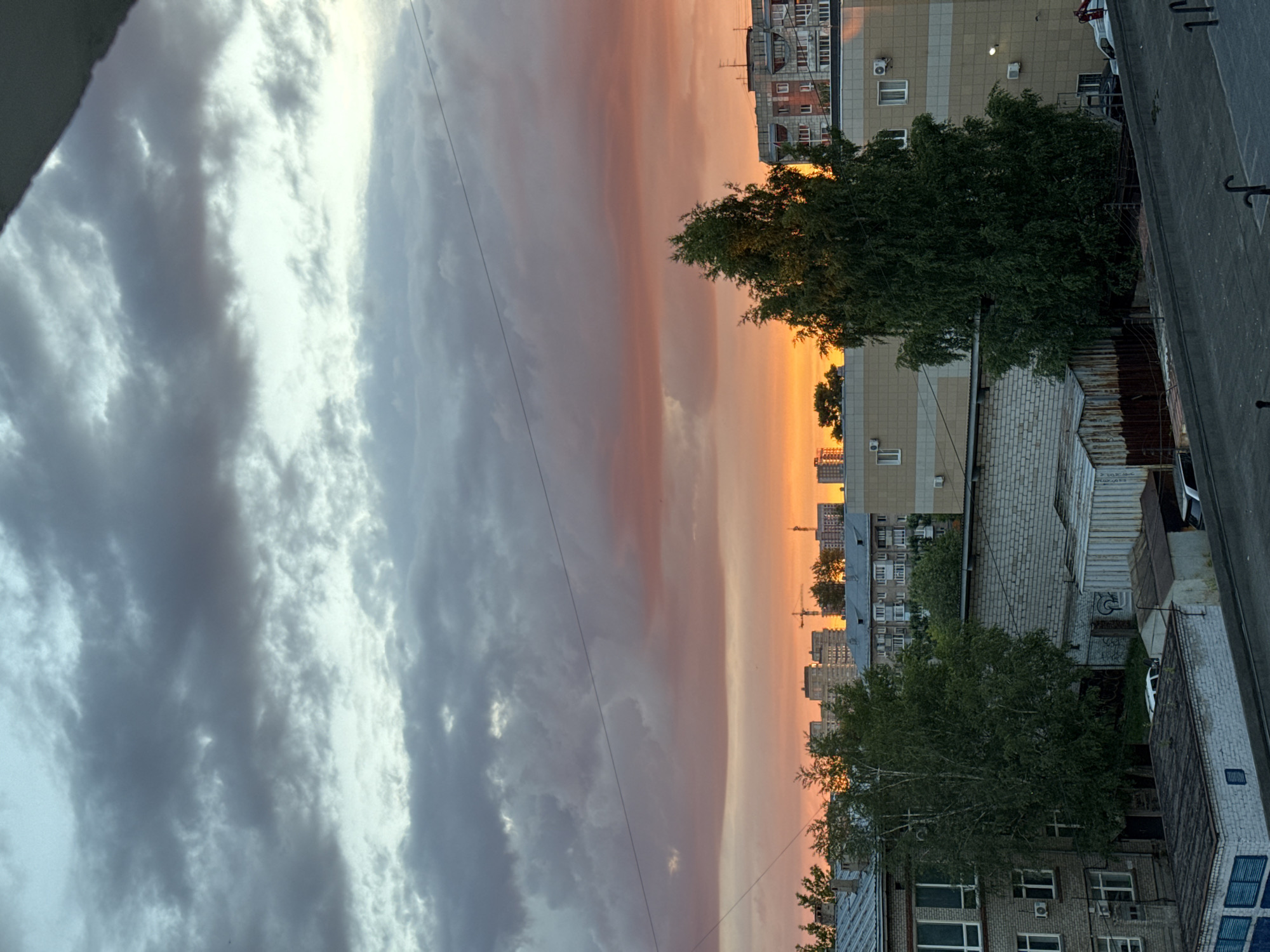 Perm skyline at golden hour, clouds and city silhouettes