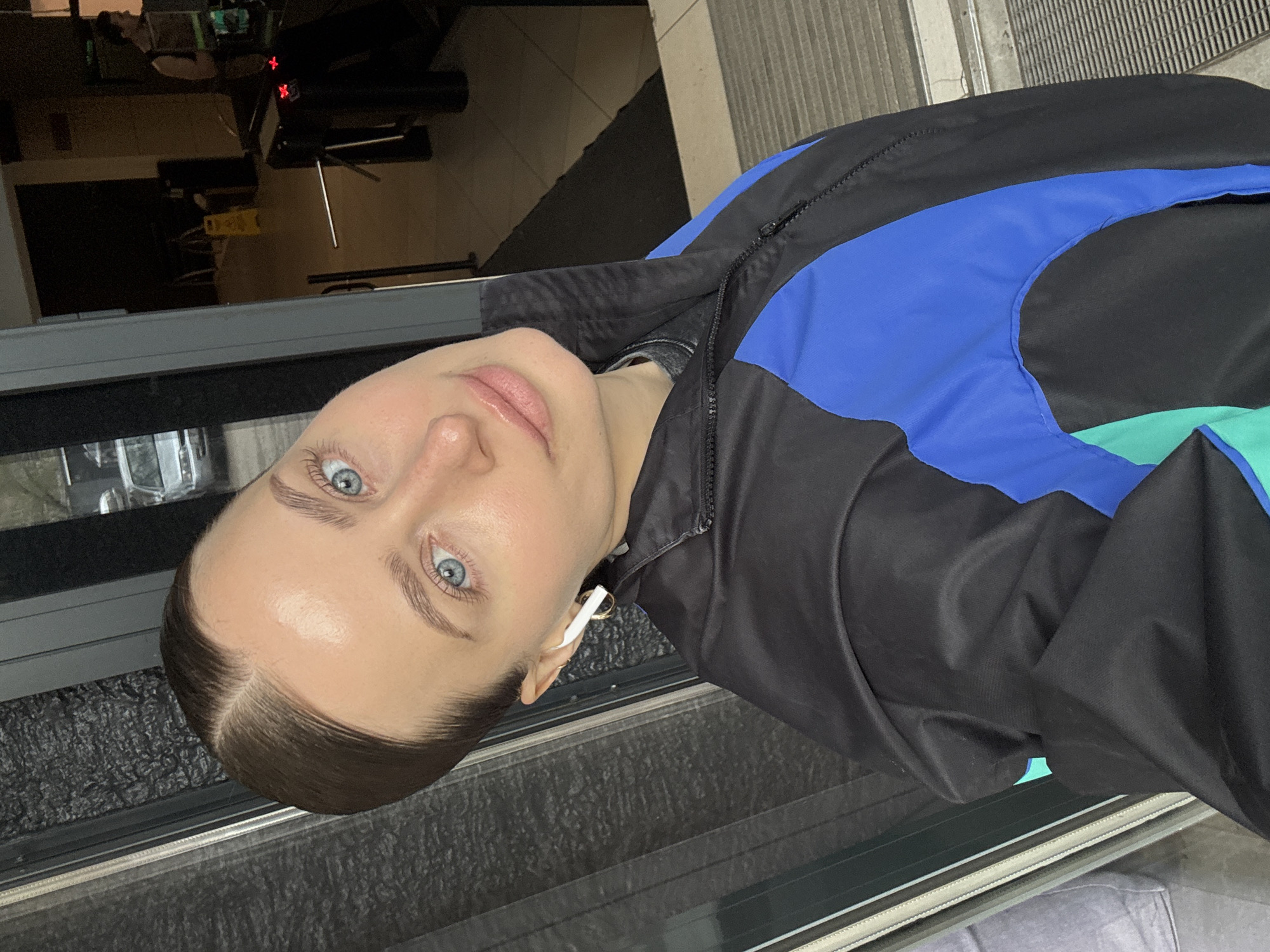Woman photographed in selfie wearing jacket with earbuds, Krasnoyarsk
