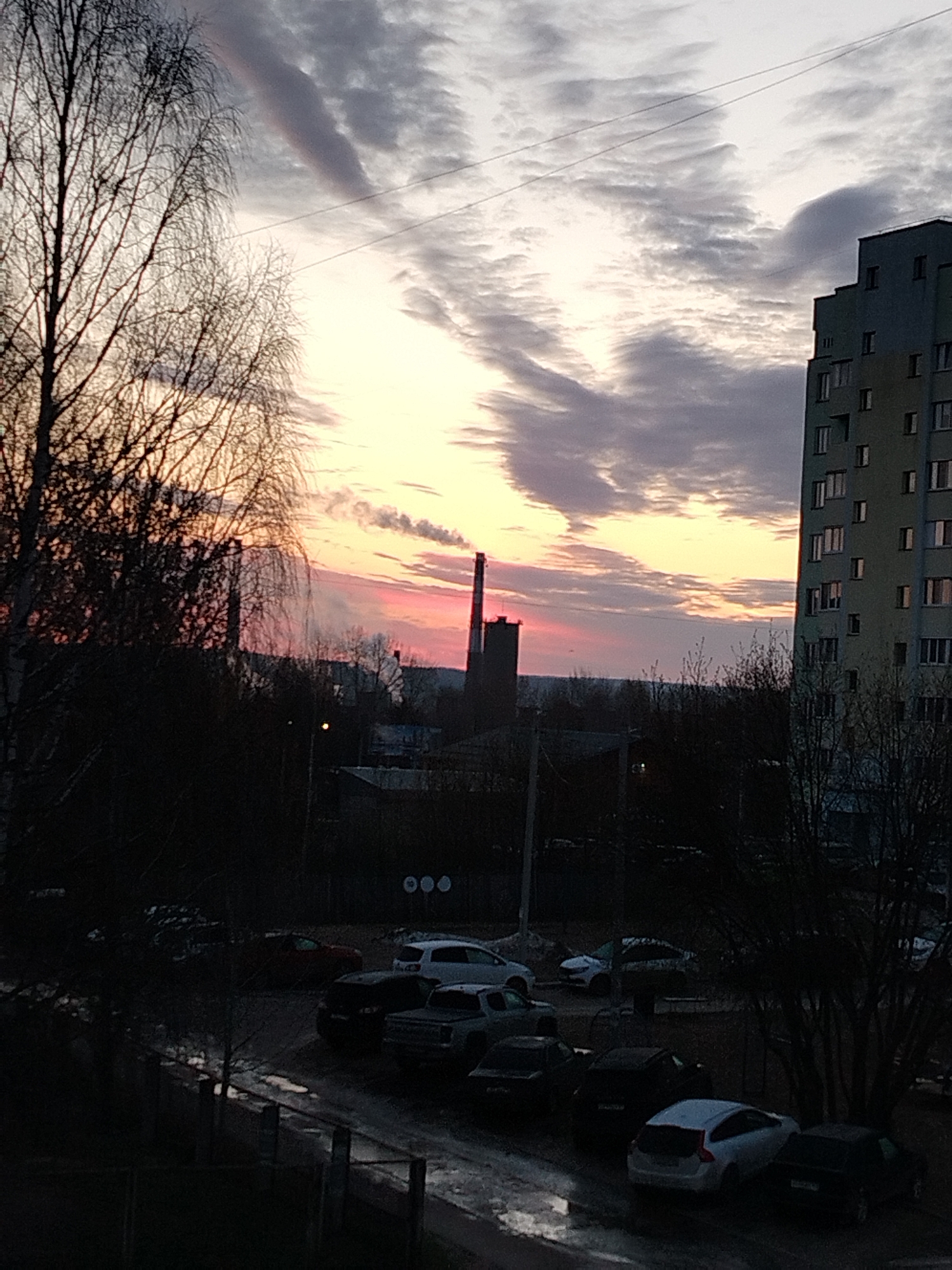 Dawn cityscape captured with dramatic illuminated clouds over urban area