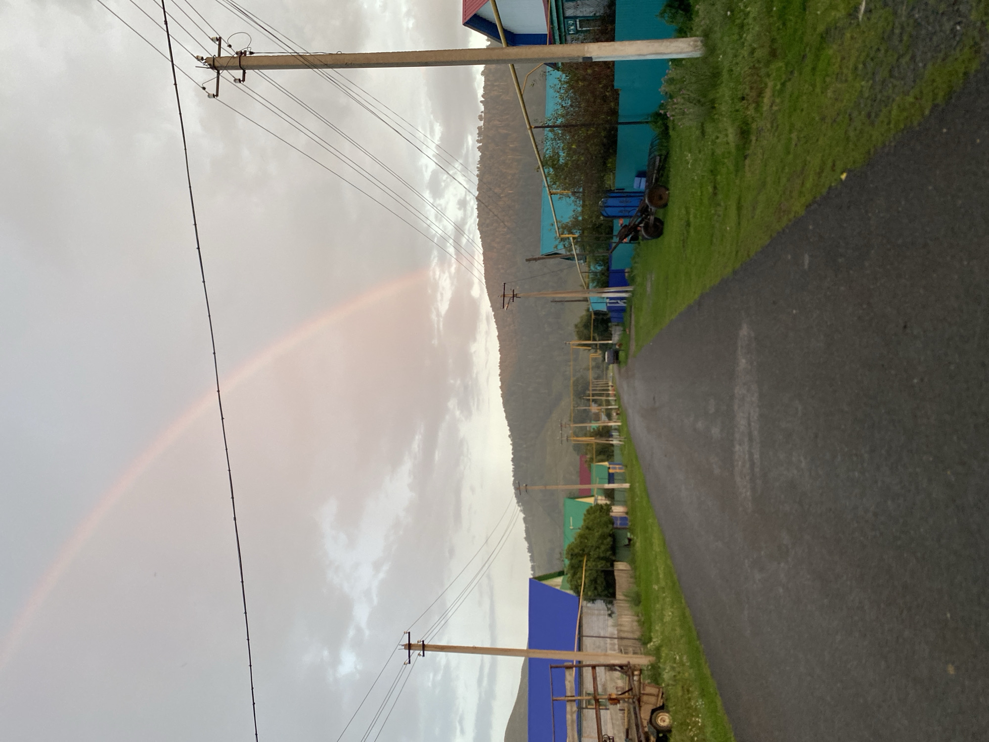 Post-rain summer evening with kids and a rainbow in rural Russia