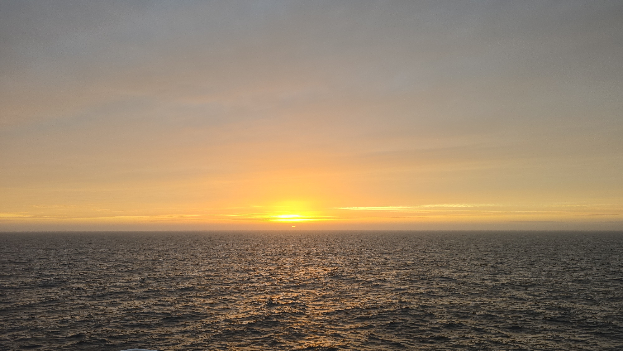 Ocean sunset captured with orange-yellow sky gradients