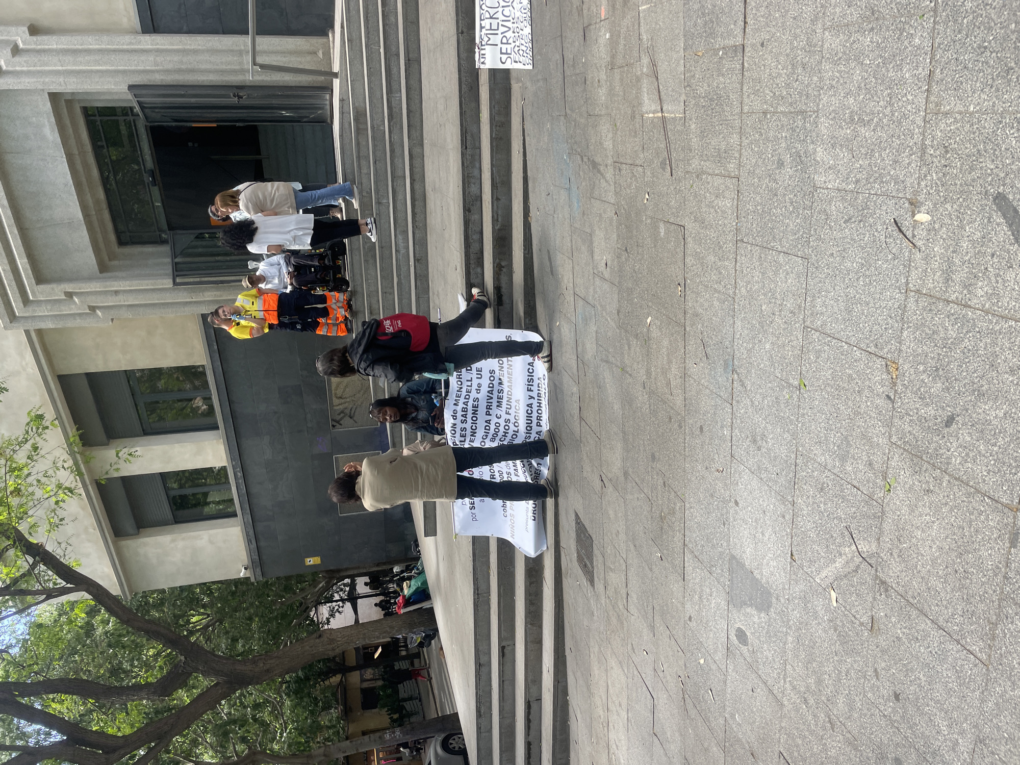Gathering with protest sign observed on Barcelona building steps
