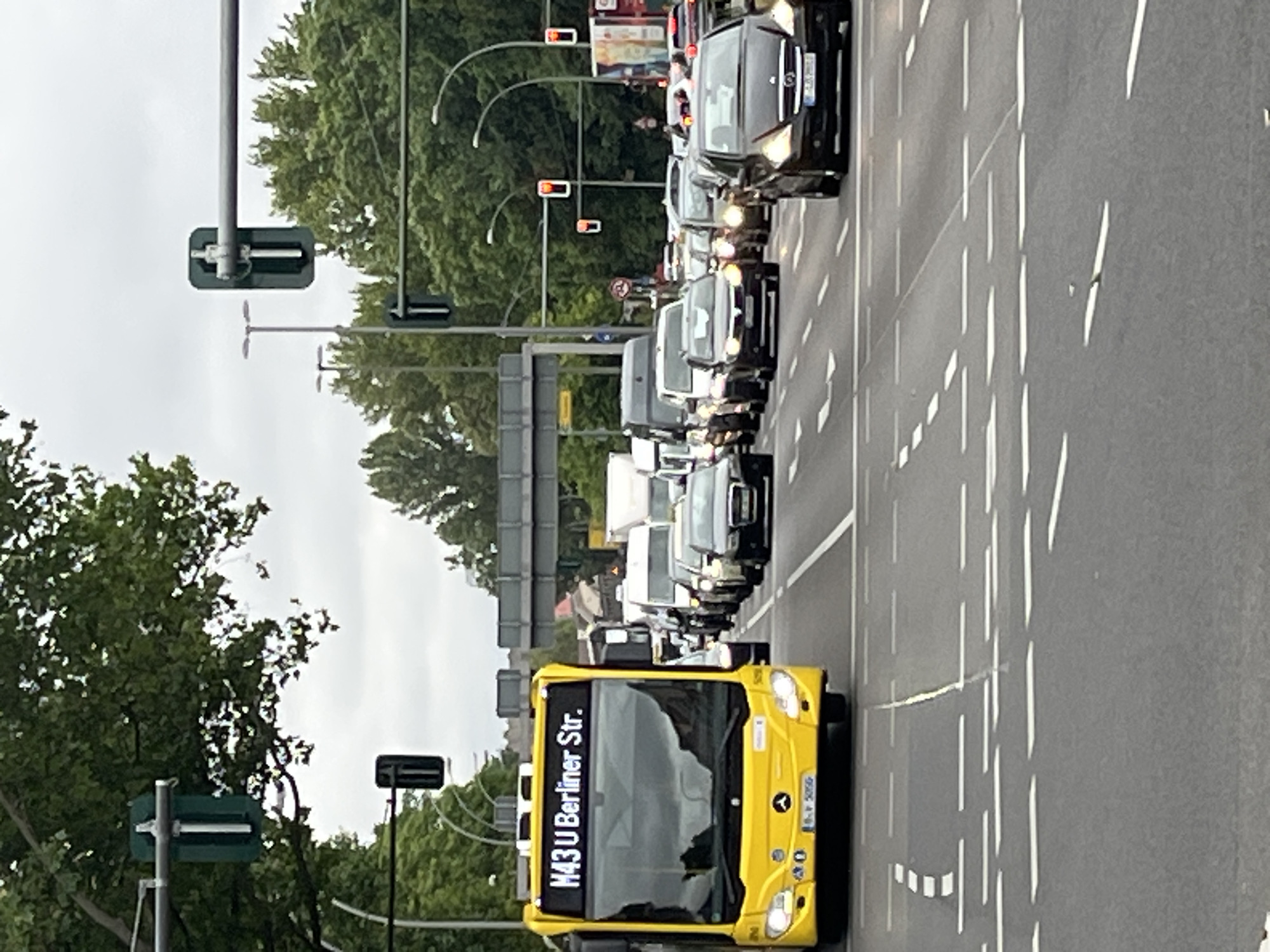 Berlin intersection activity with yellow buses and street life