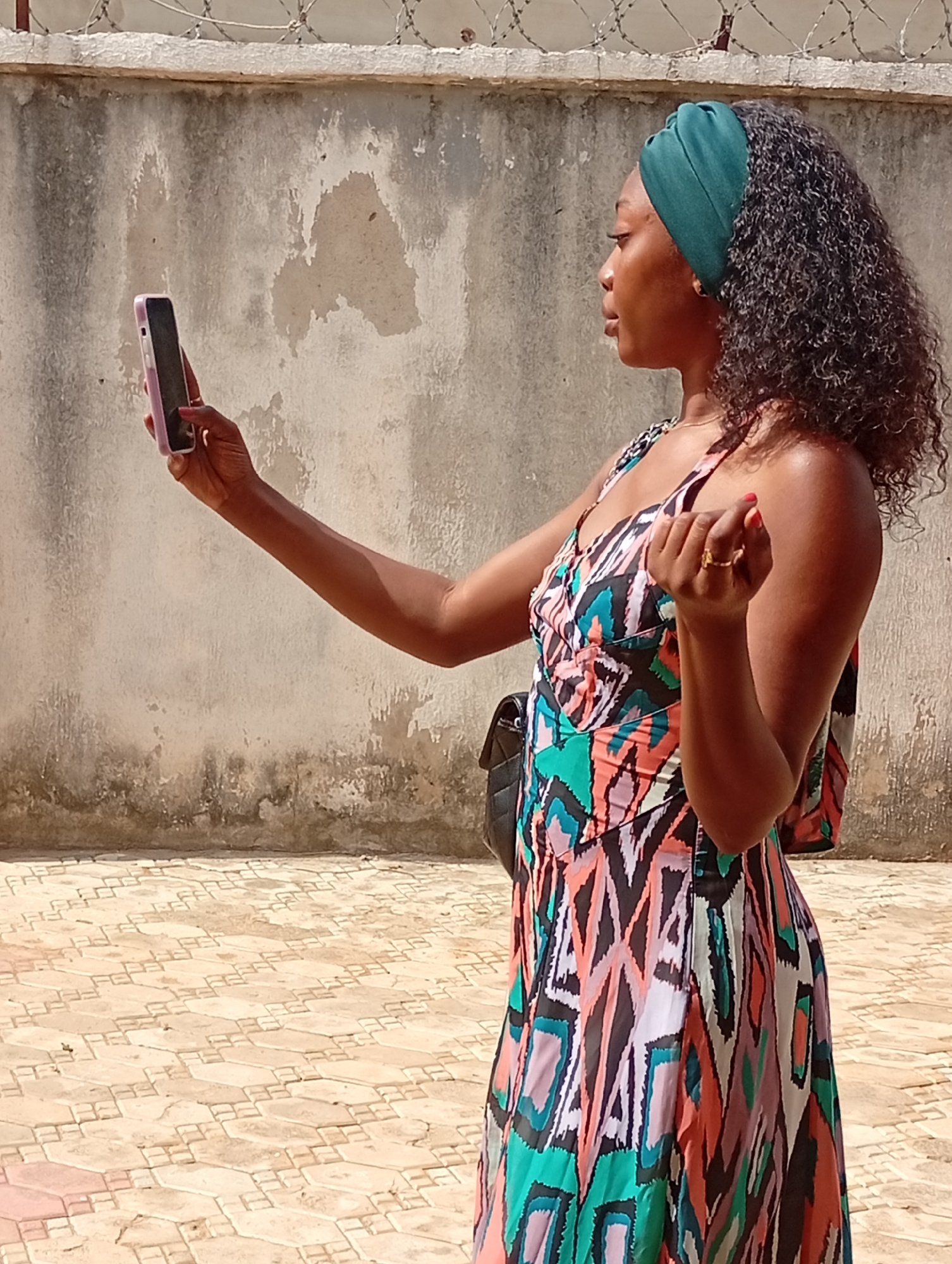 Woman takes smartphone selfies in Rido, Nigeria