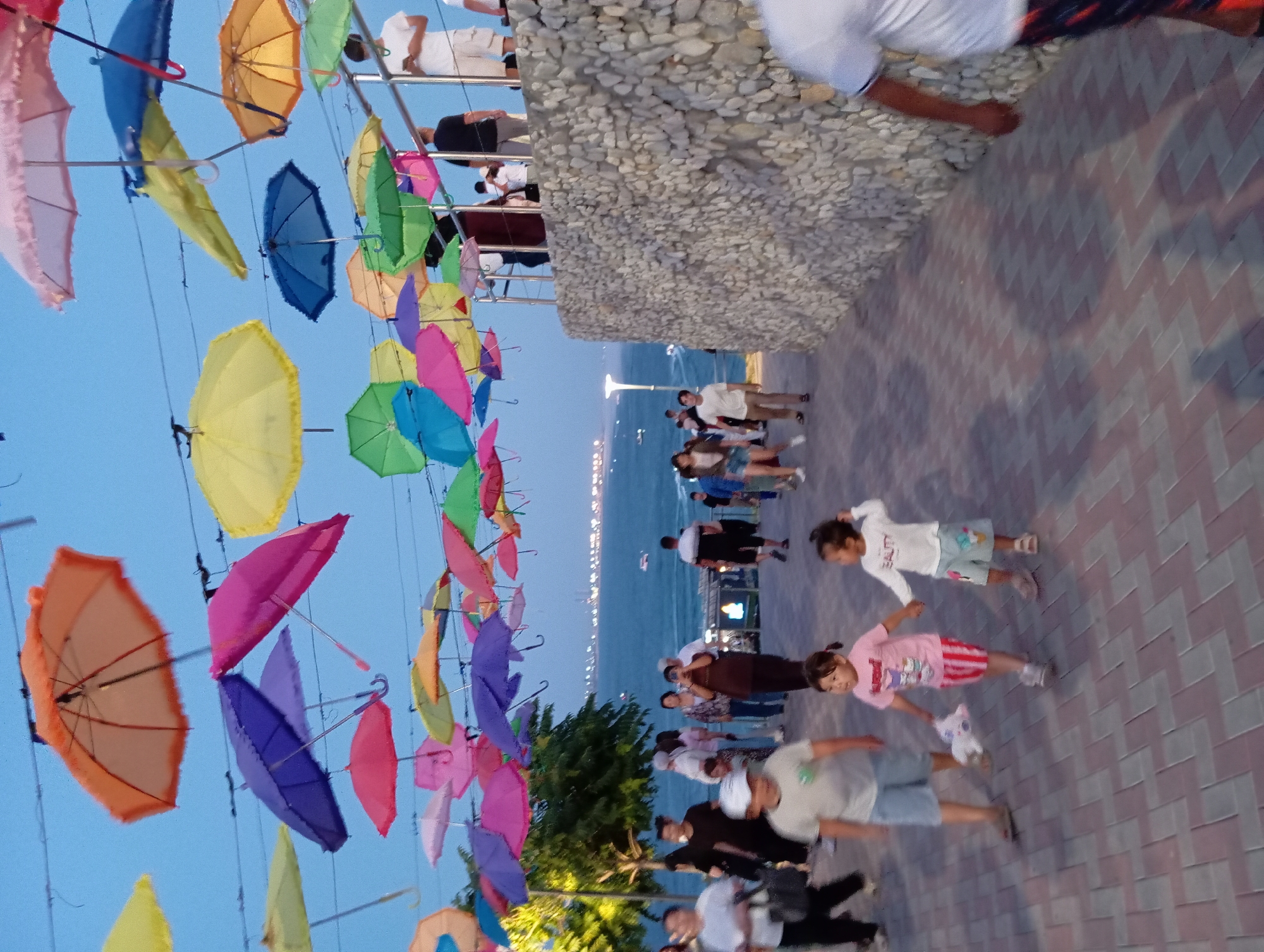Aktau's umbrella-lined Caspian promenade at dusk