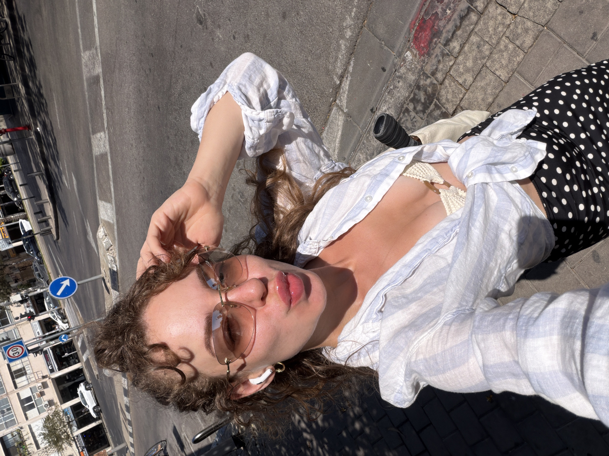 Sunny sidewalk selfies in Tel Aviv, midday.