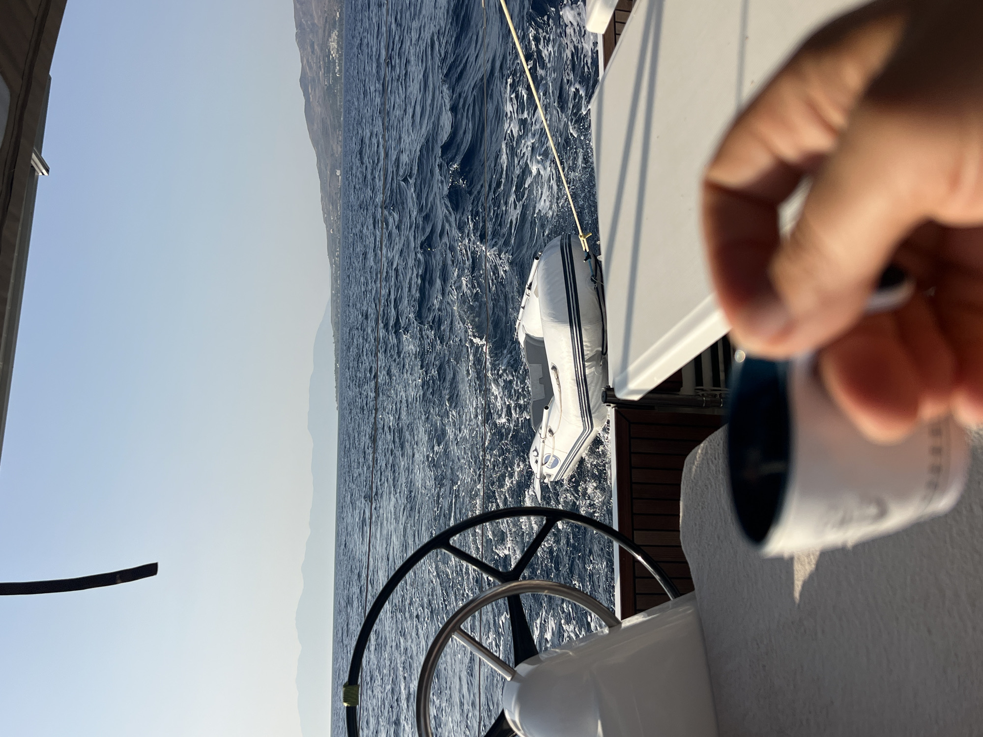 Sailing open water on a calm, sun-bright day