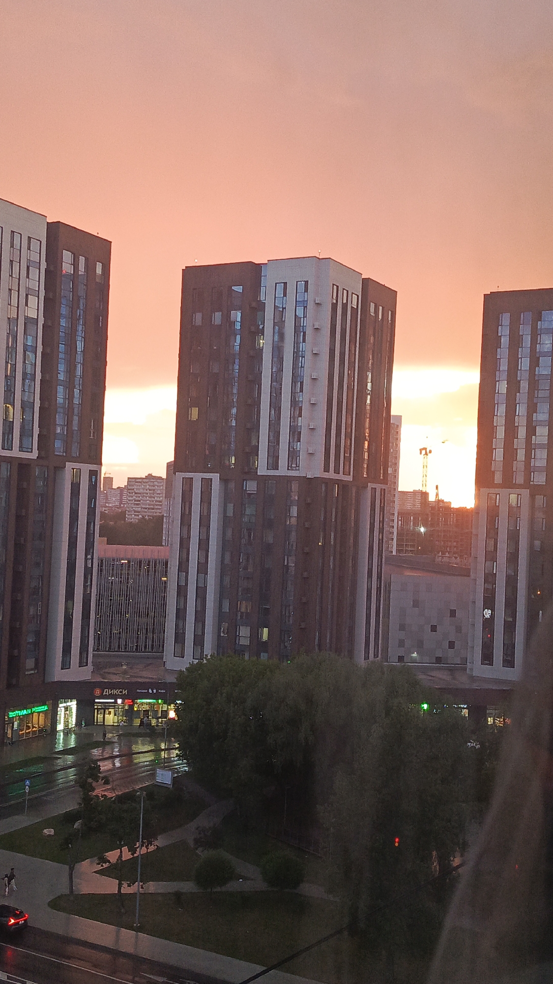 Rainy evening in, city sunset outside