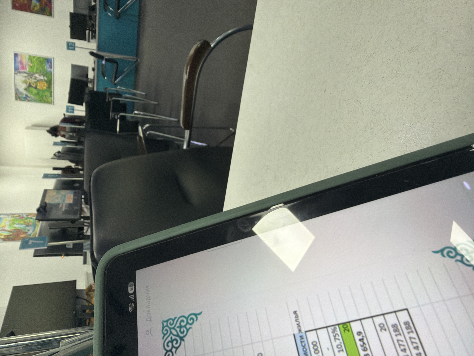 Inside an Astana office: workstations, brochures, and a calculator