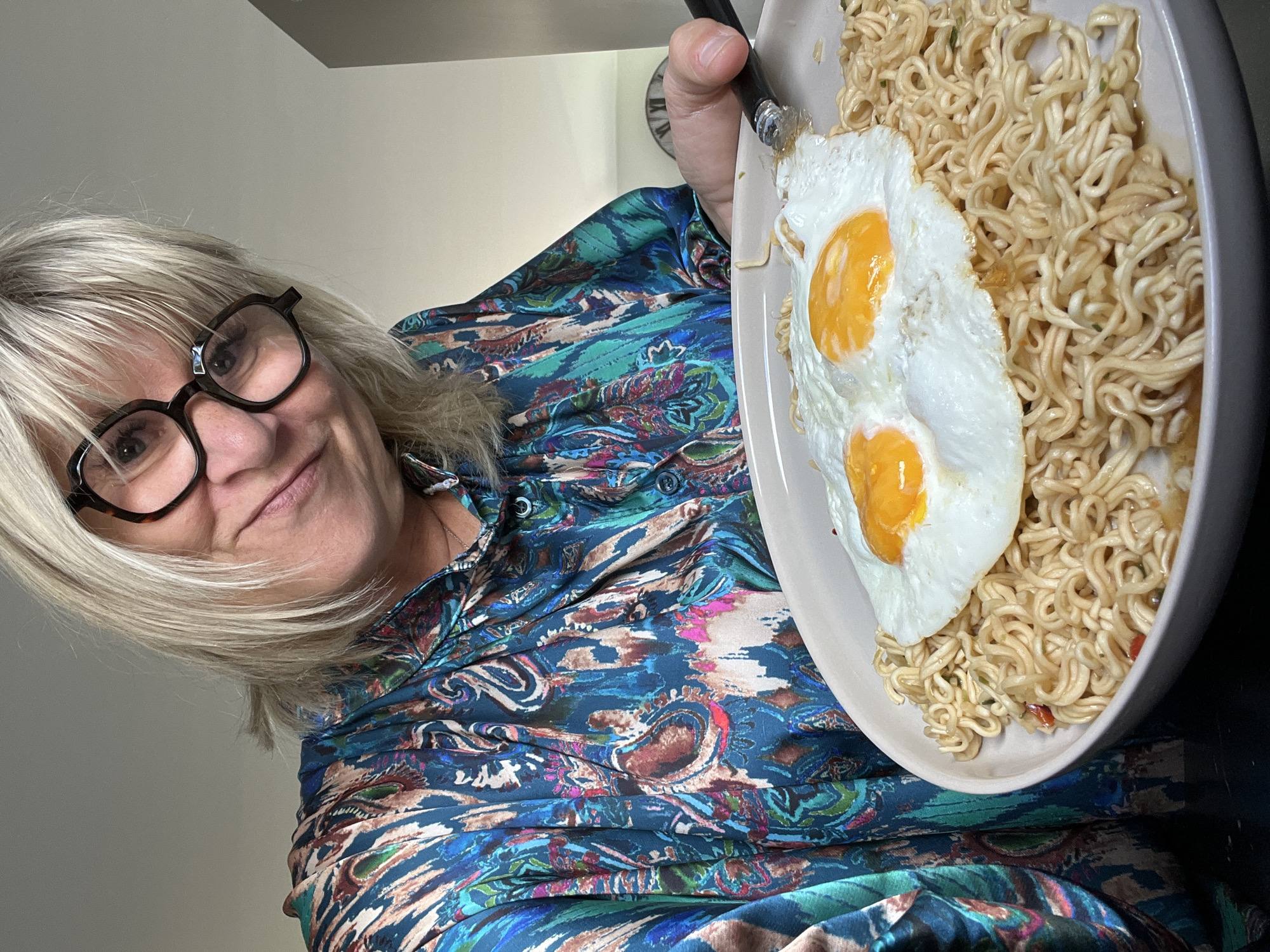 Woman holds noodle breakfast in Chambœuf home