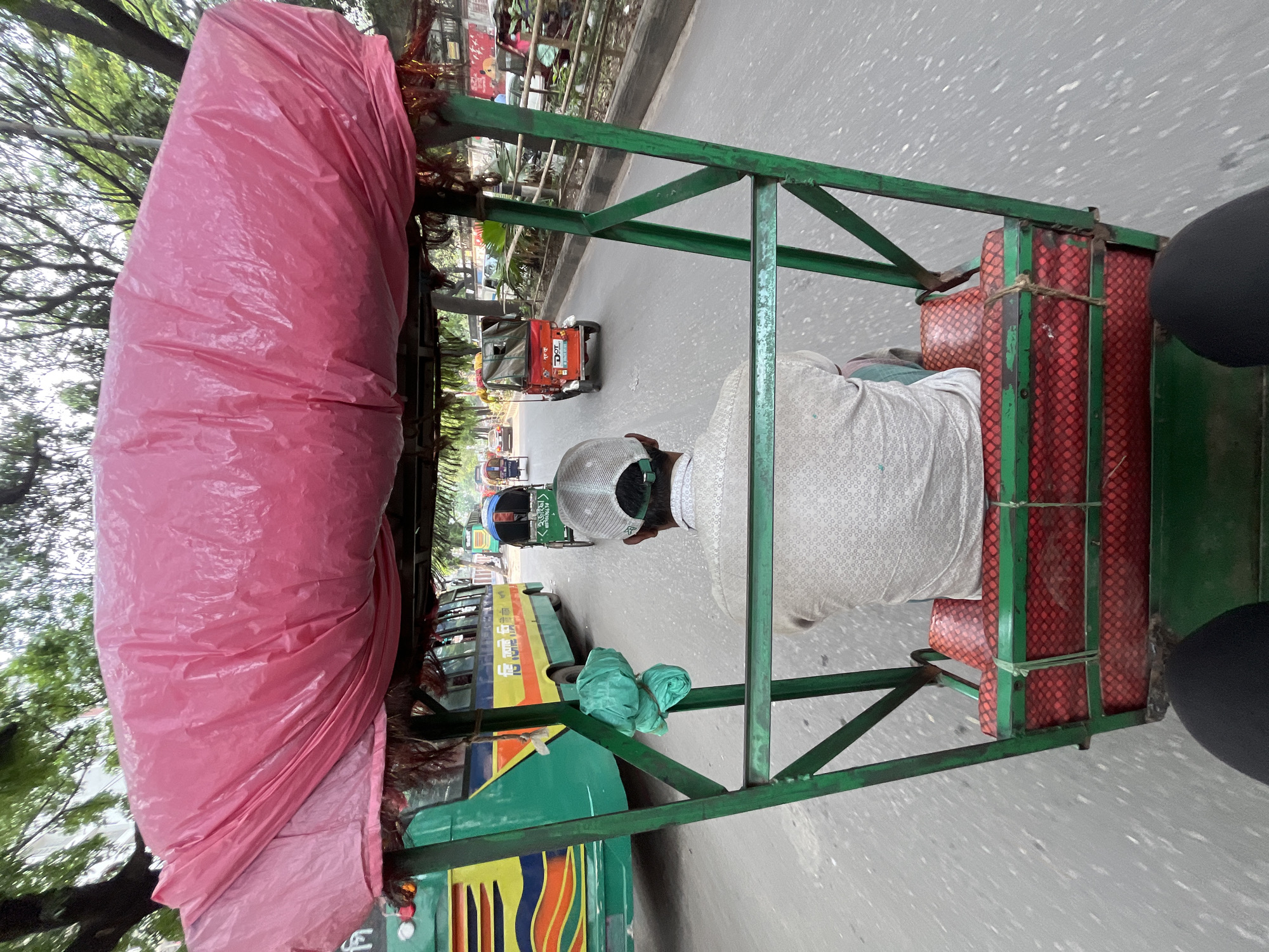 Rickshaw ride captured in Dhaka street scene