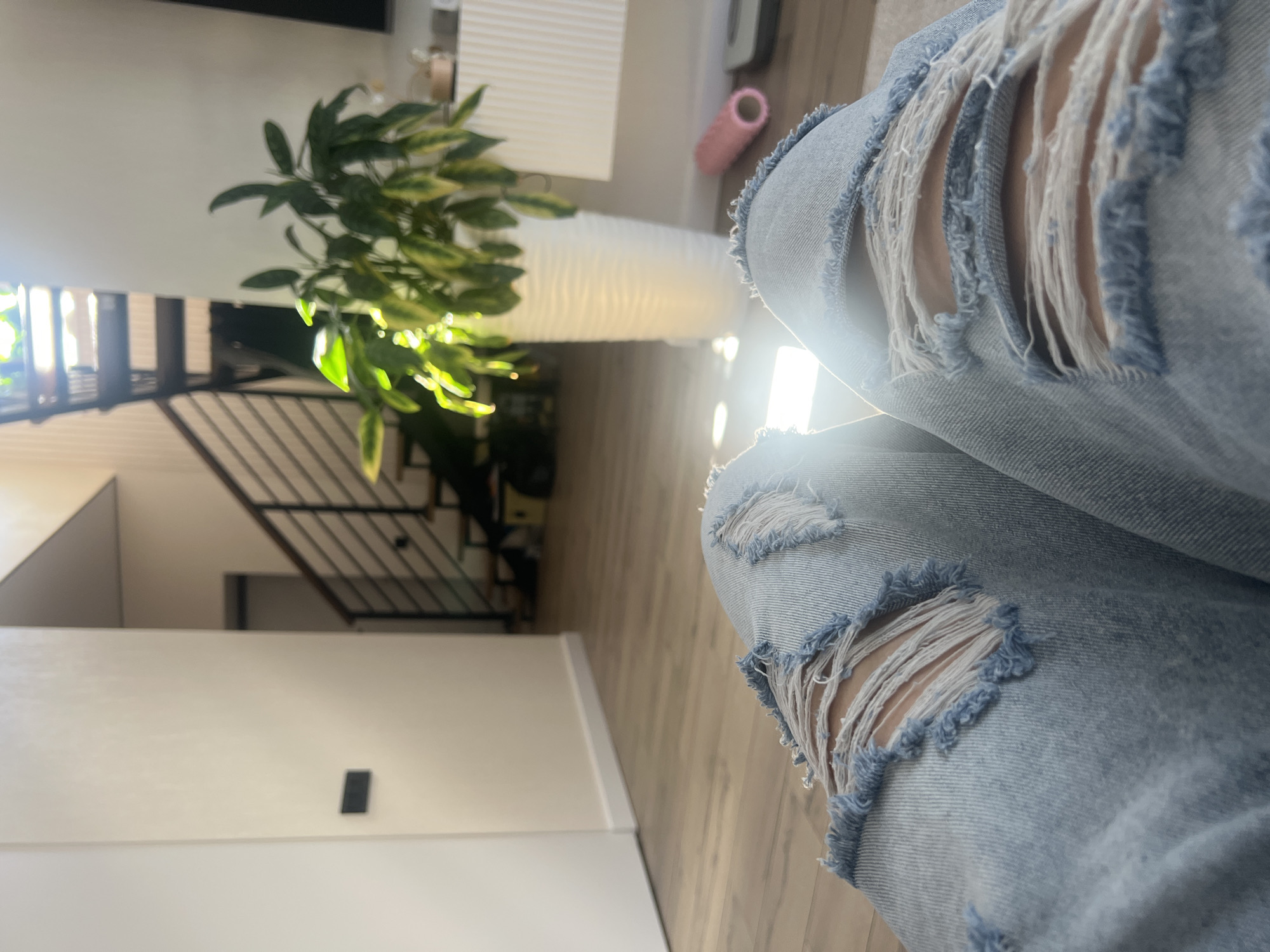Ripped denim detail shots in a sunlit Votkinsk home