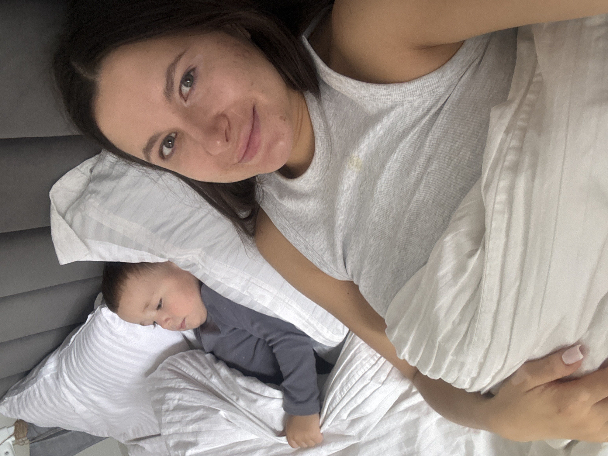 Mother and child share morning moment in Odintsovo bedroom
