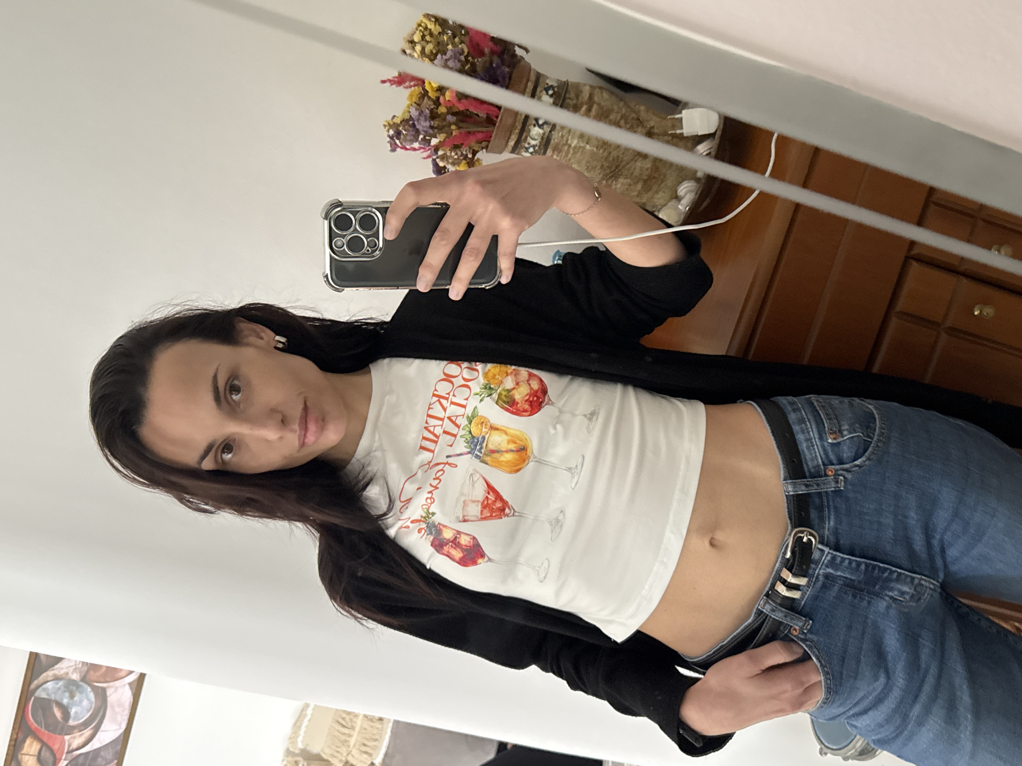 Woman takes mirror selfies in cocktail graphic top, Chania