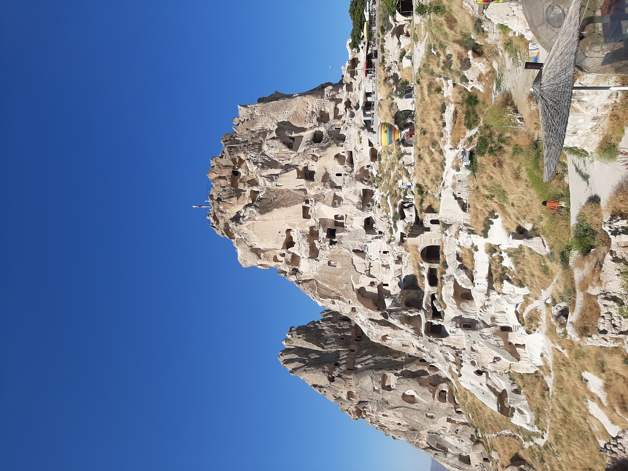 Exploring Uçhisar's cave fortress and Cappadocian landscape.