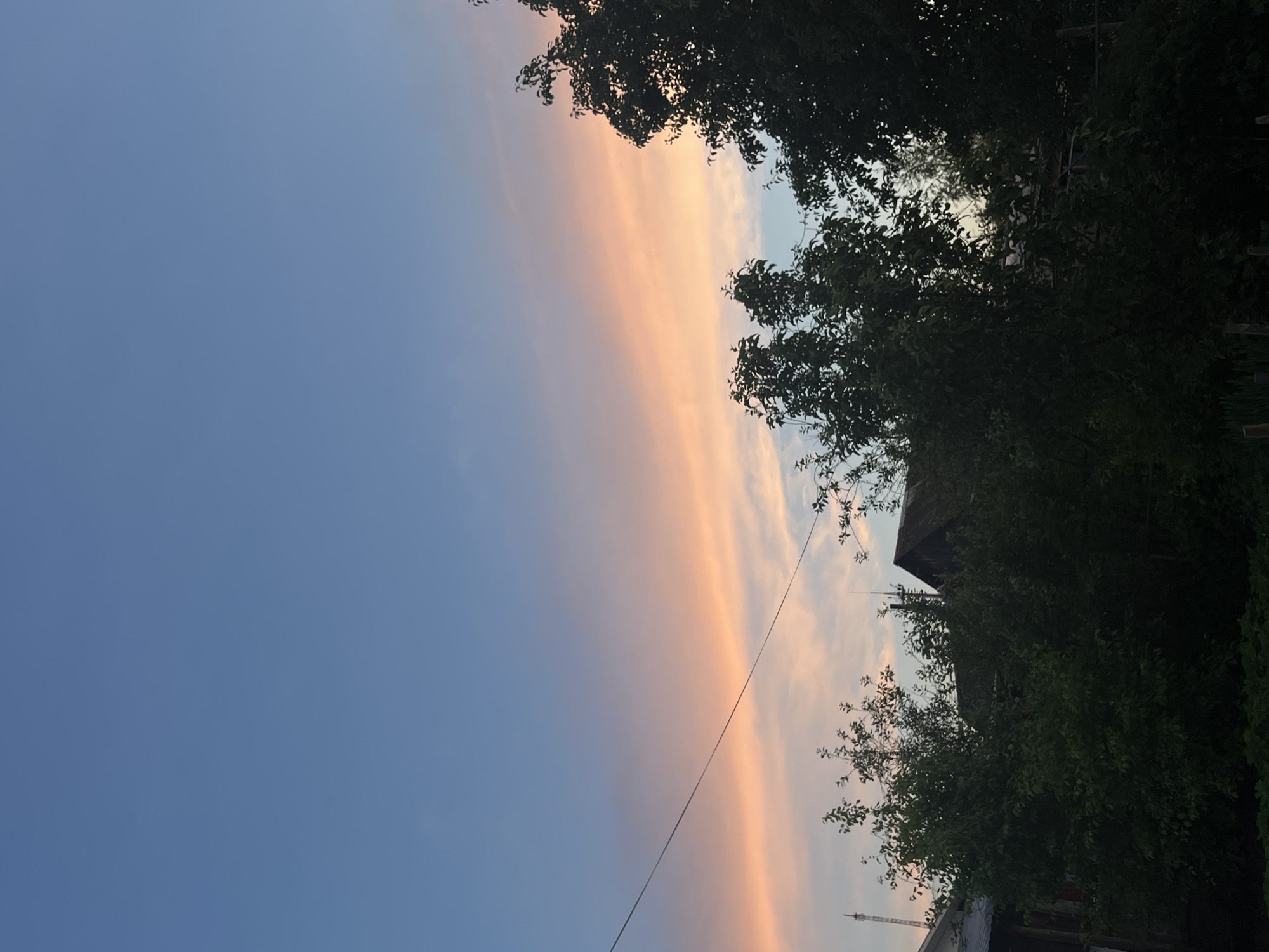 Woman takes selfie during dramatic sunset in Chaikovsky, Russia