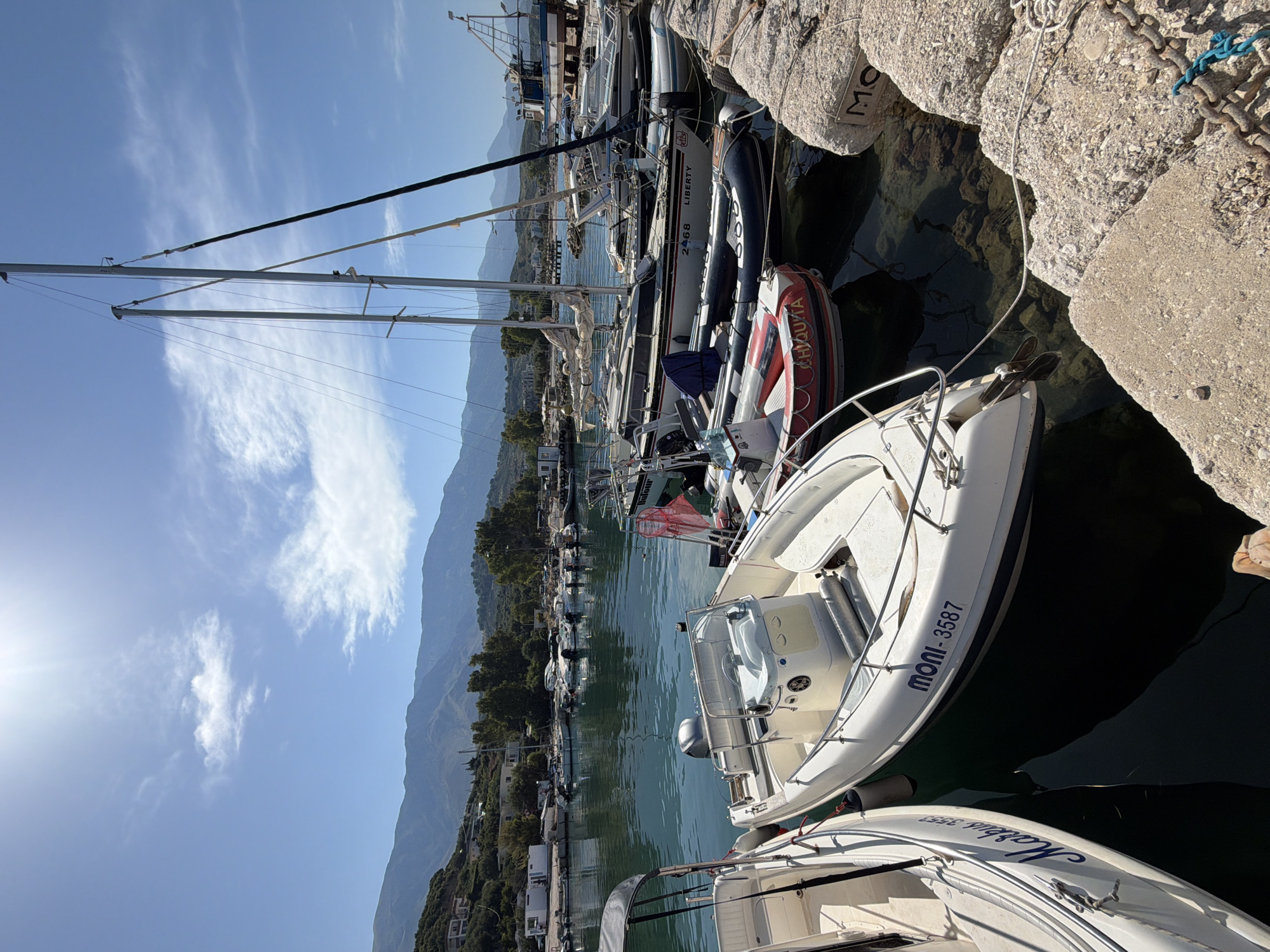 Sunny morning at Orikum's marina and rocky shoreline