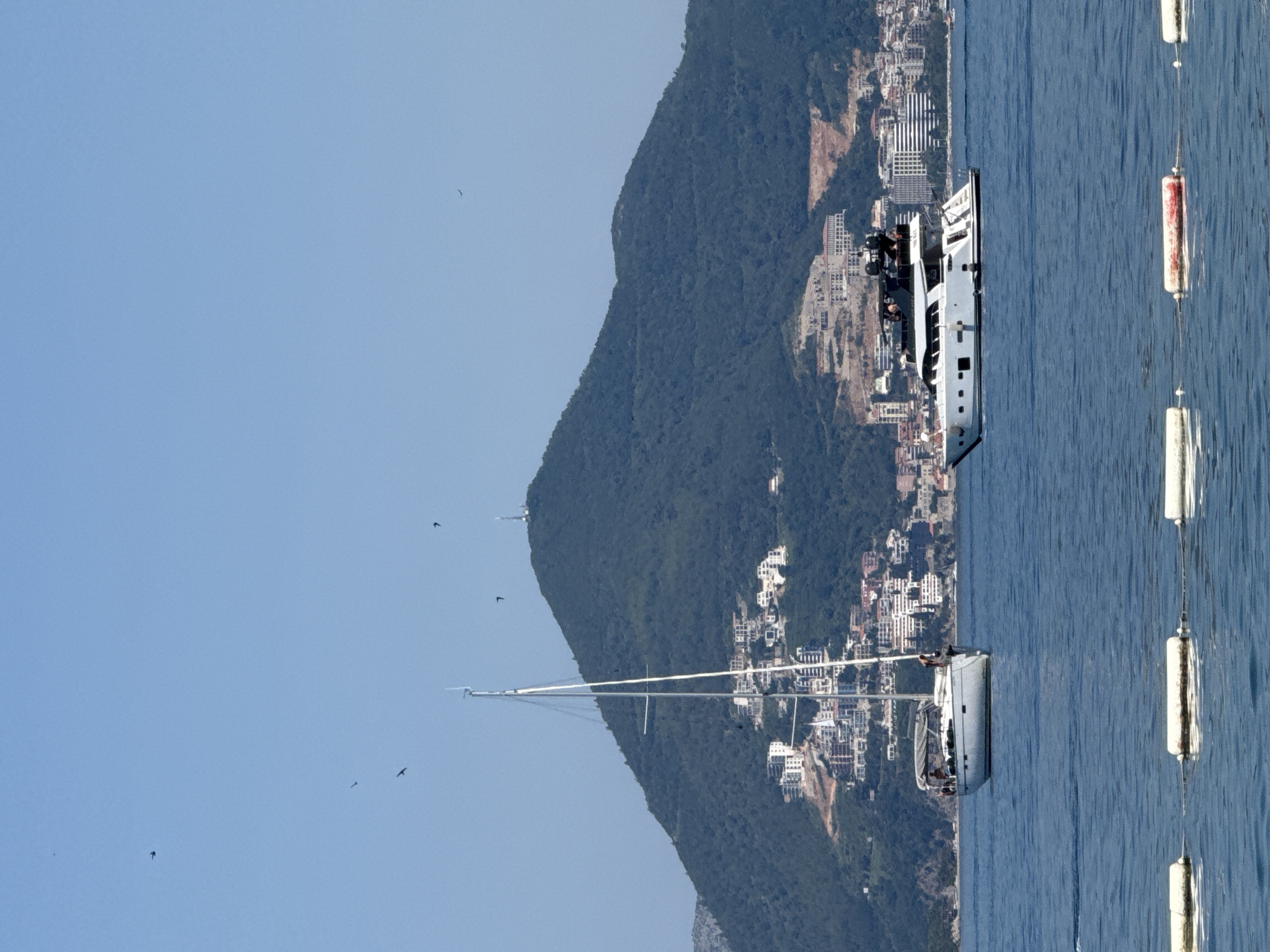 Boat traffic and coastal scenes off Budva on a clear morning