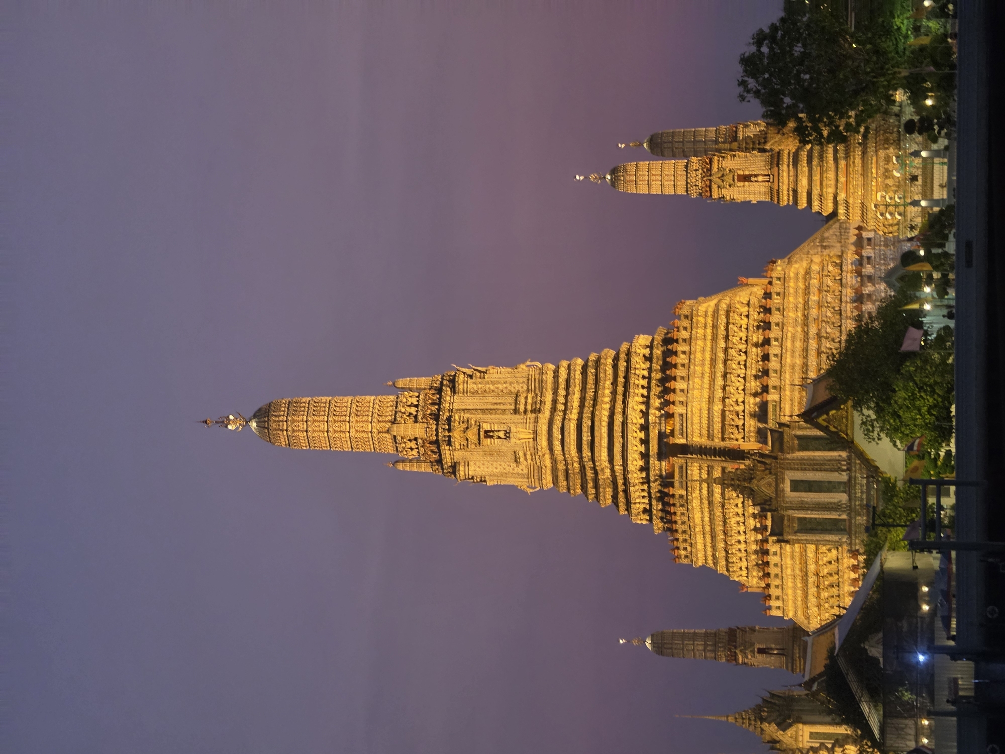 Tourist explores Bangkok's Wat Arun temple district during evening hours