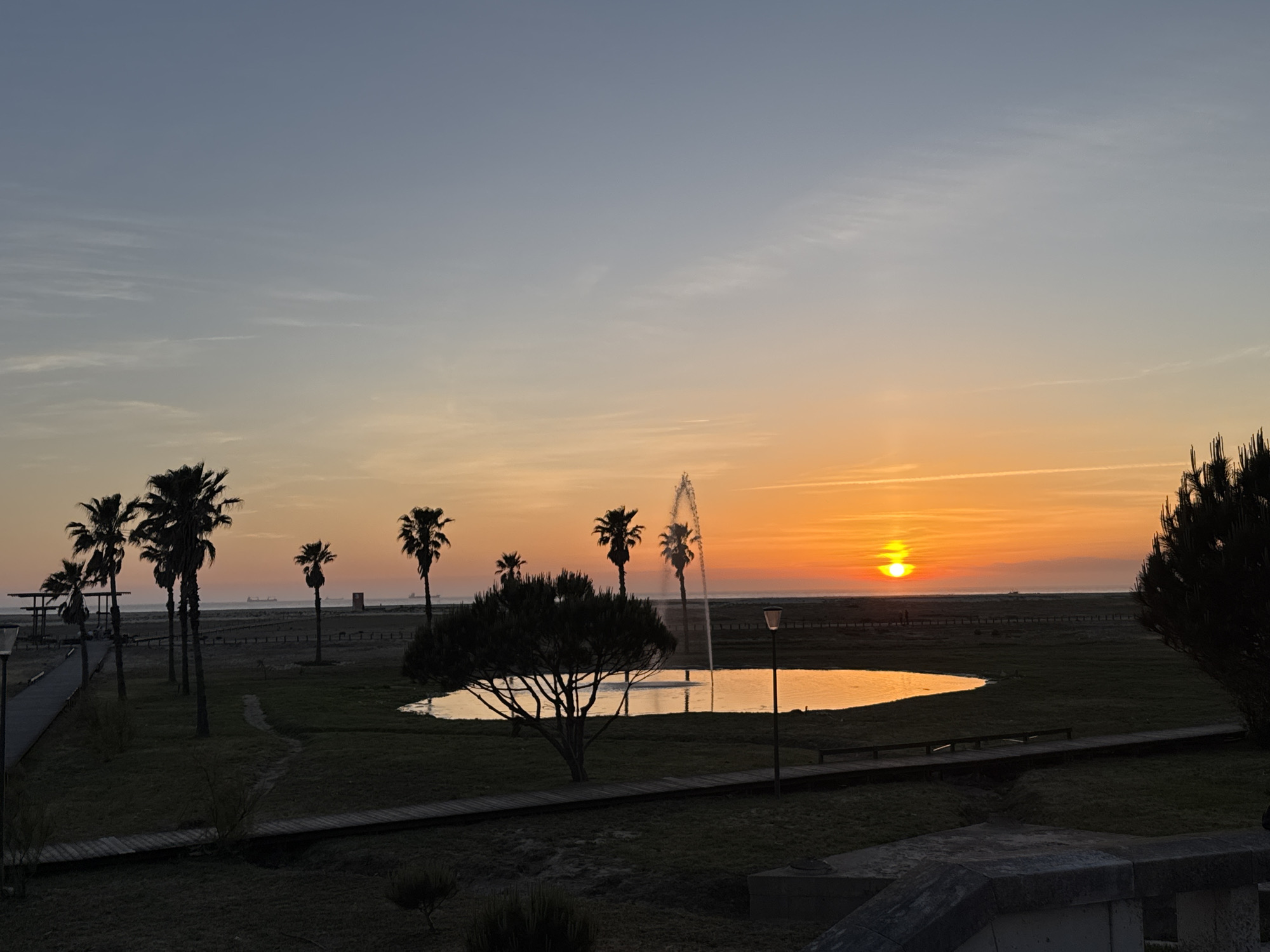 Sunset captured over Figueira da Foz waterfront with fountain display