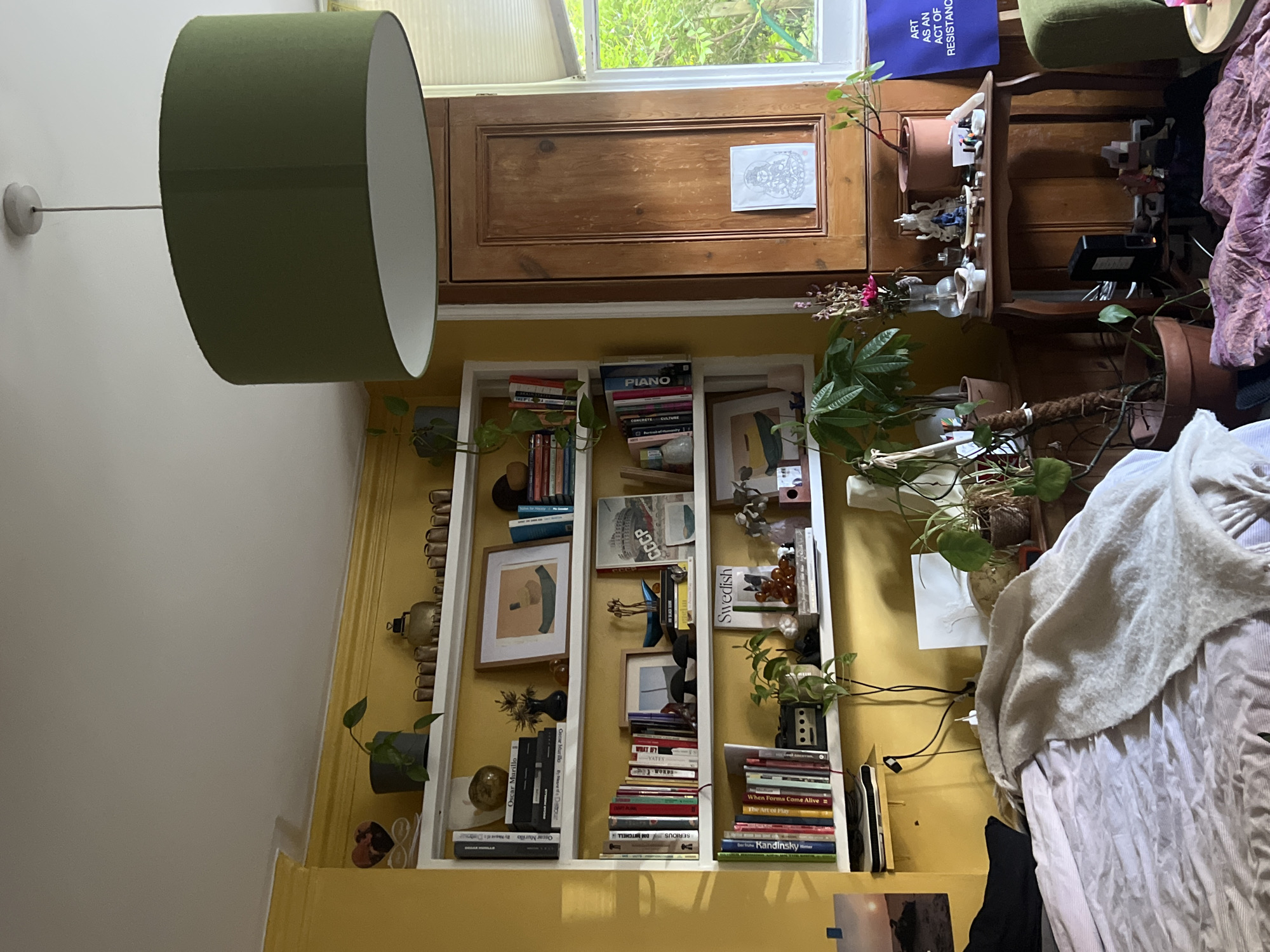 Inside a characterful London home, yellow walls and quirky art