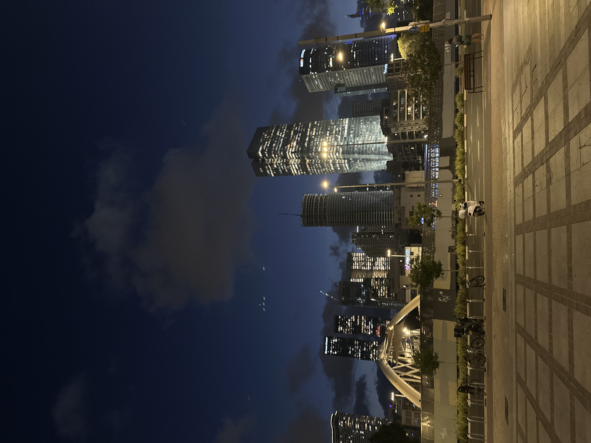 Dusk in Tel Aviv: city skyline and koi pond