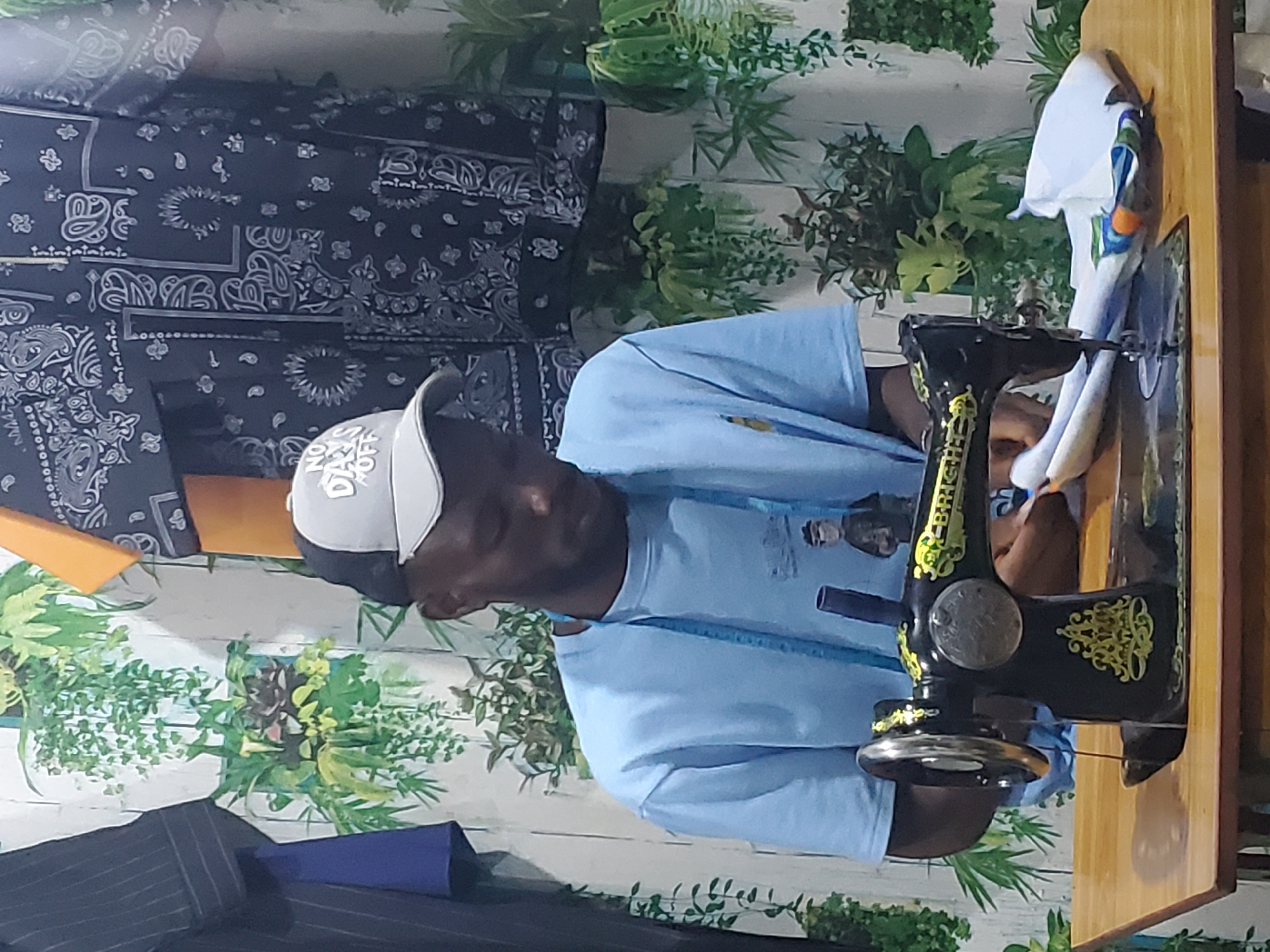 Inside a Jos tailor shop, a full garment-making session unfolds