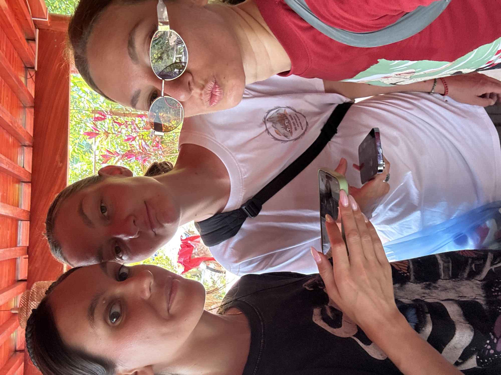 Three women take selfies in Vietnamese commune