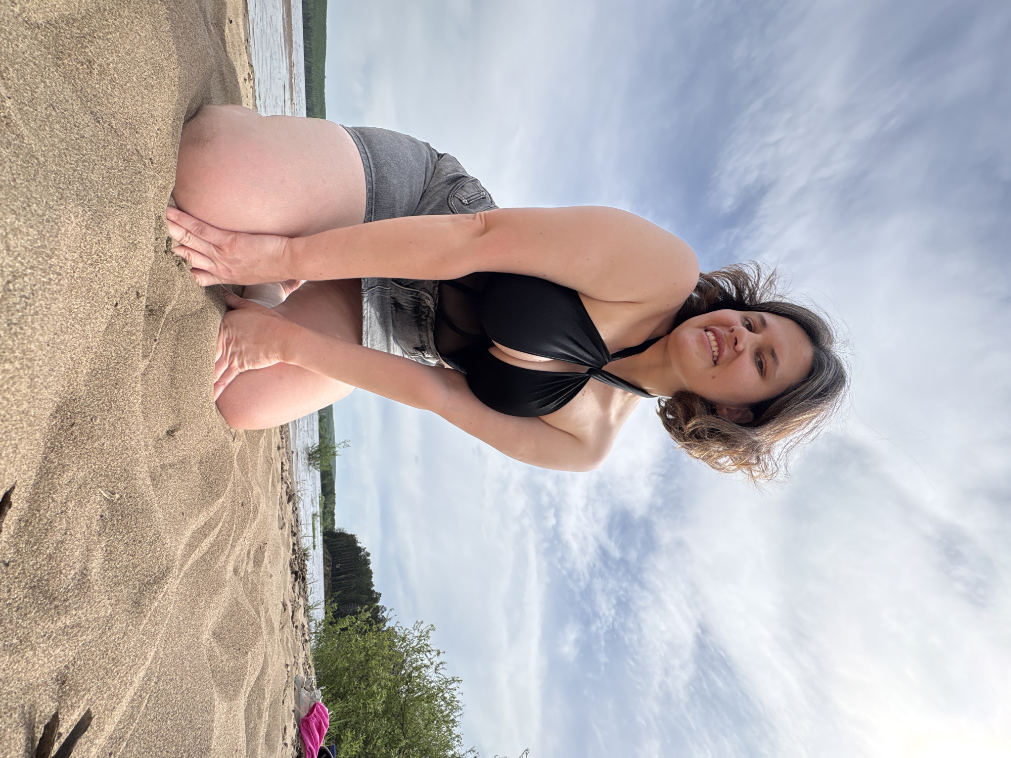 Woman photographed on beach in Chaikovsky, Russia morning scene