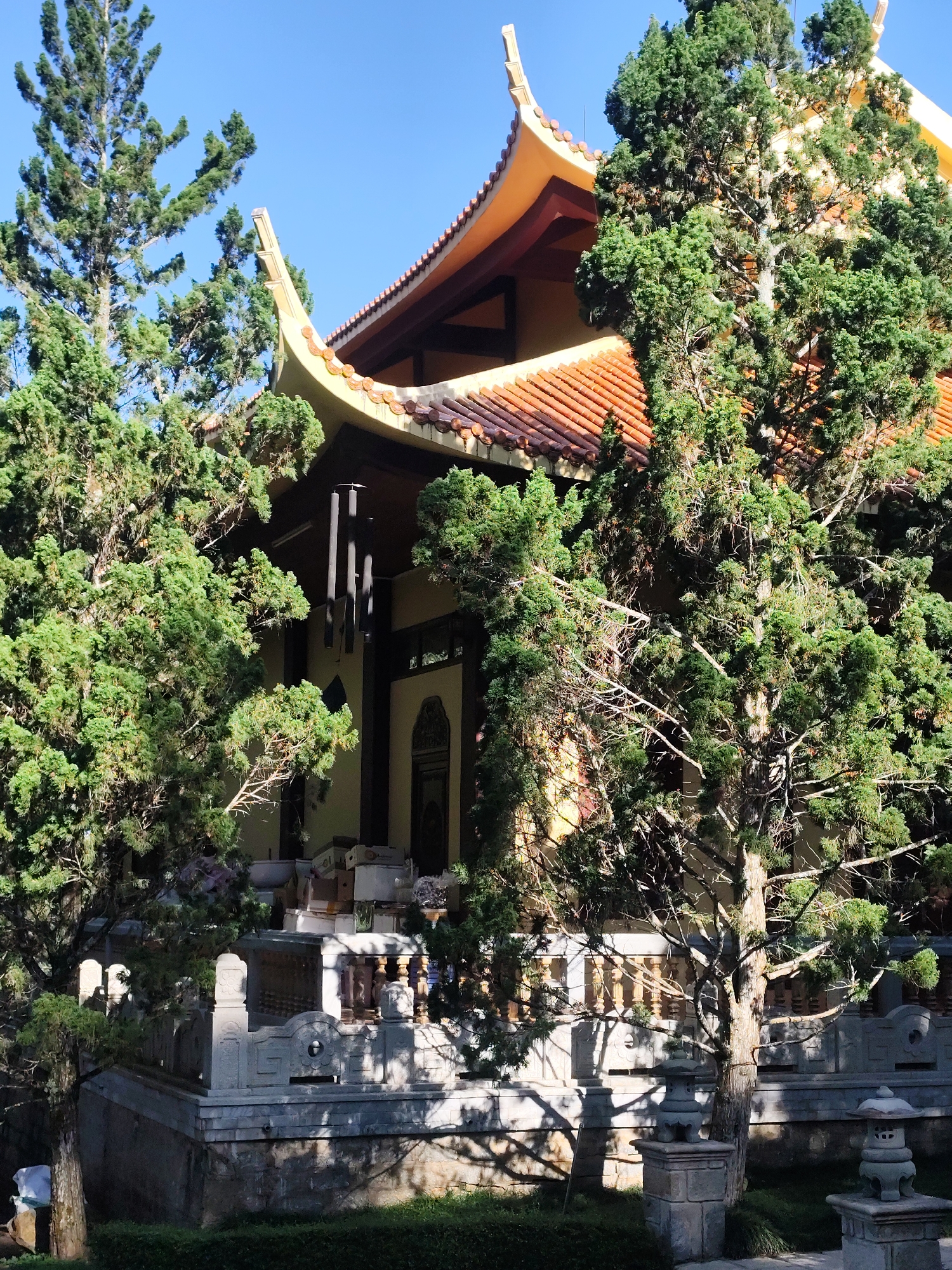 Traditional East Asian temple grounds with gardens and waterside scenery